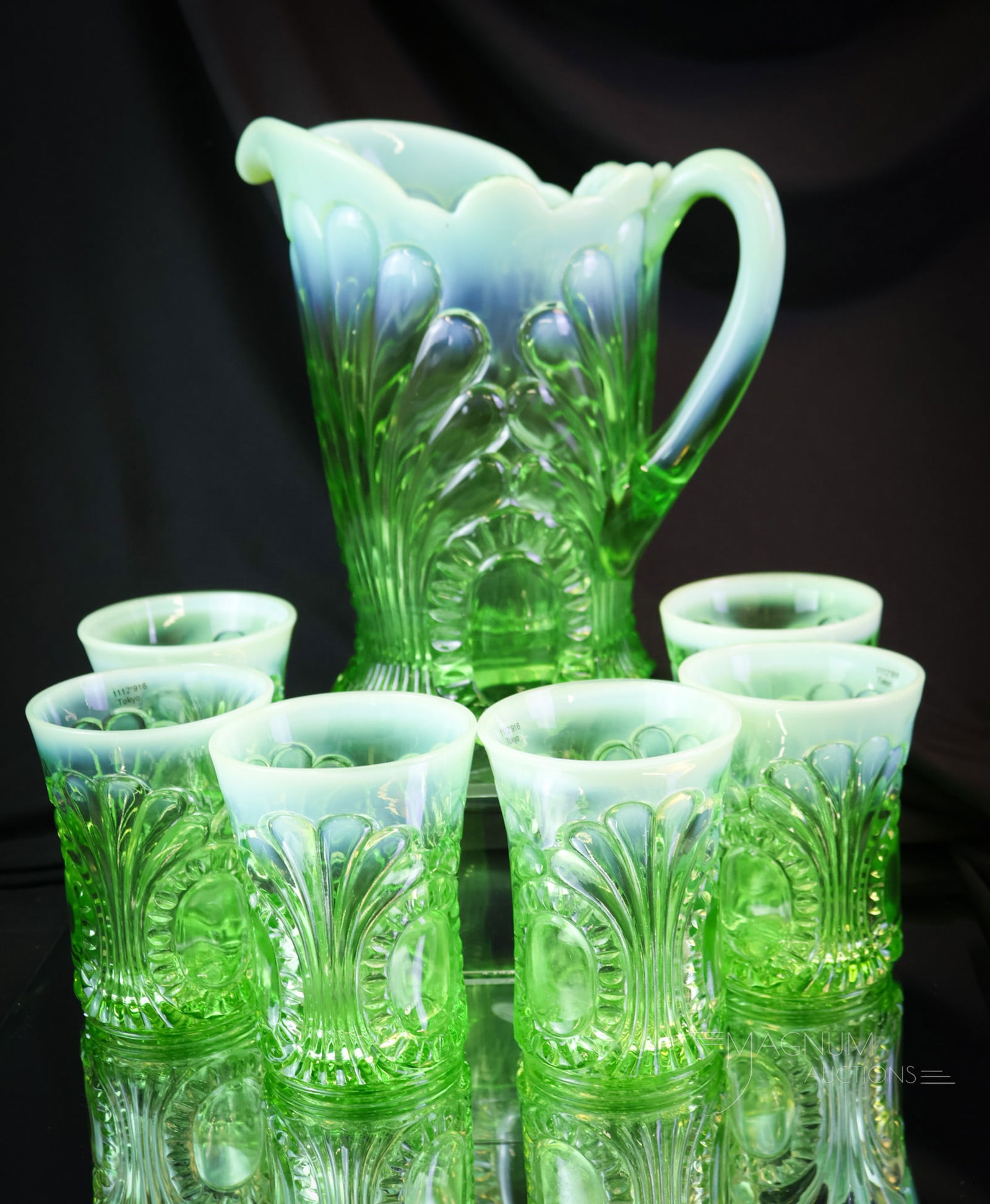 7 pc Set Green Opalescent Victorian Glass Tokyo Water Set: A striking set! This is a seven-piece water set in the Tokyo pattern. Each piece has super opal and coloring. The tallest measures 8 3/4". SHIPPING NOTICE: If you choose not to utilize the LiveAuction