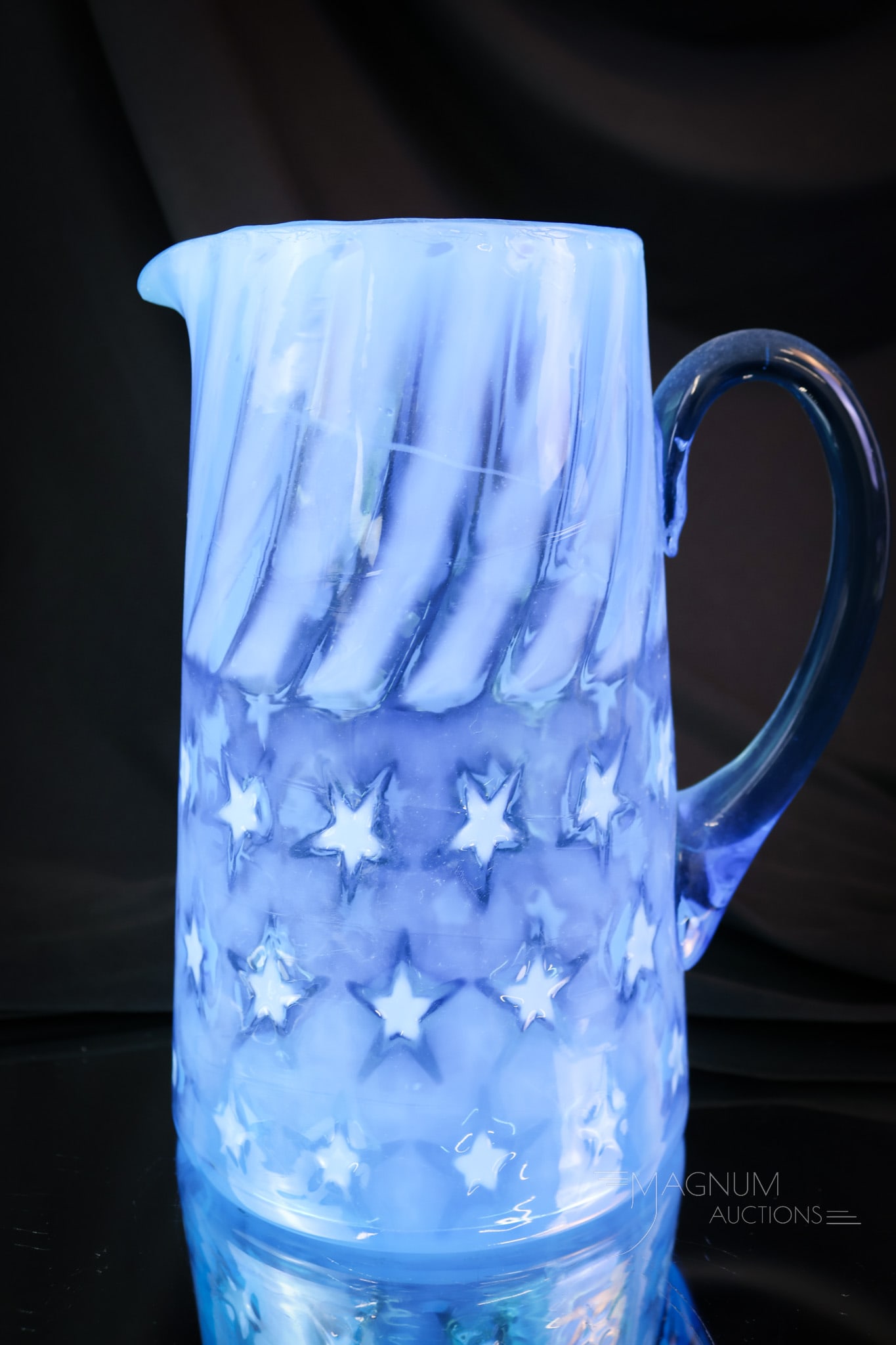 Victorian Blue Opalescent Glass Stars & Stripes Water Pitcher: A beautiful find in a tankard Victorian opalescent glass water pitcher. This is a blue pitcher in the Stars and Stripes pattern. This striking example has three rows of stars. The pitcher measures 8 1