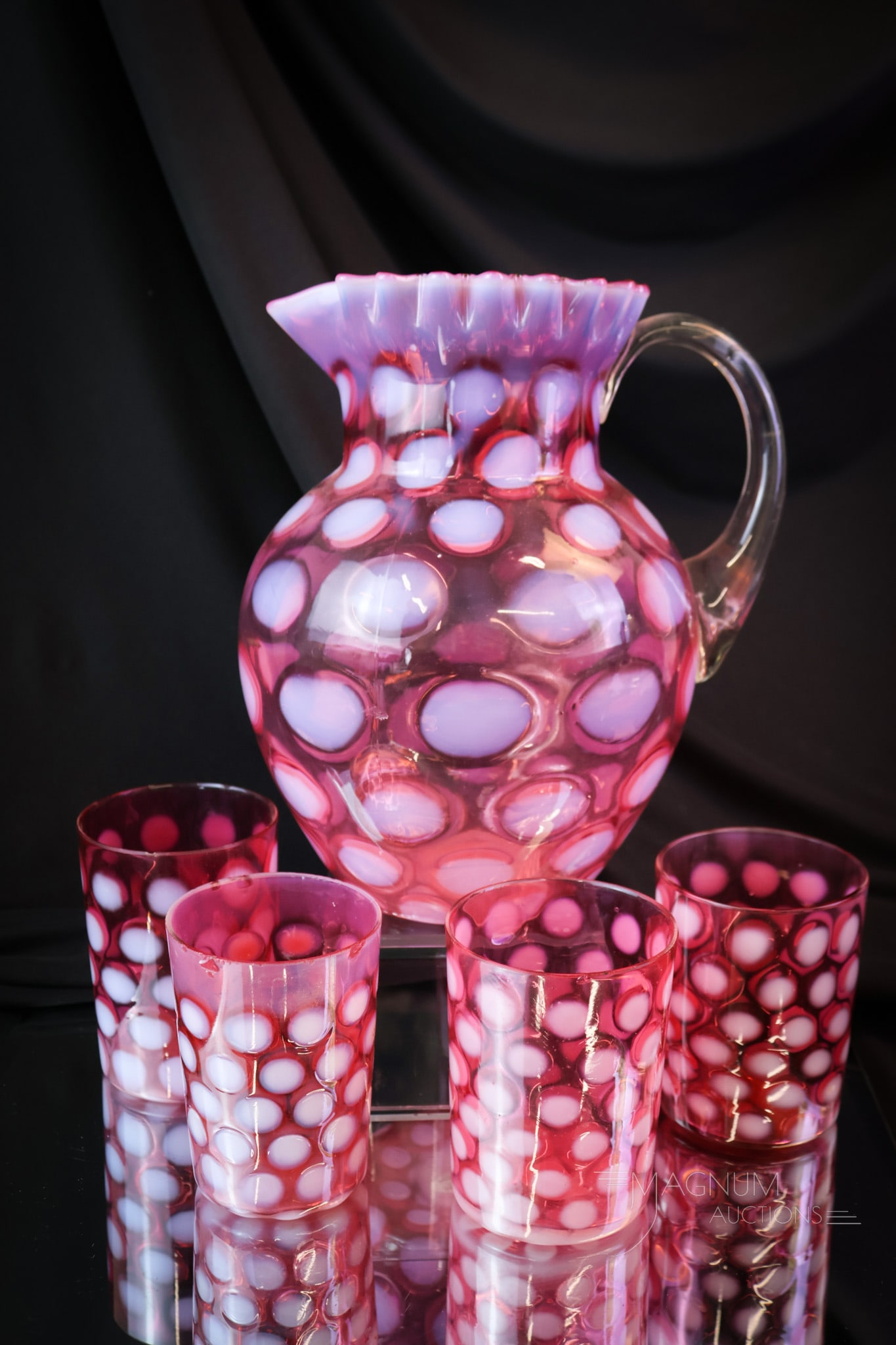 5 pc Cranberry Opalescent Victorian Glass Coin Spot Water Set: A lovely cranberry Victorian opalescent water set. This five-piece set consists of a pitcher and four tumblers. The tallest of the set measures 9". Three tumblers exhibit rim chips. SHIPPING NOTICE: I