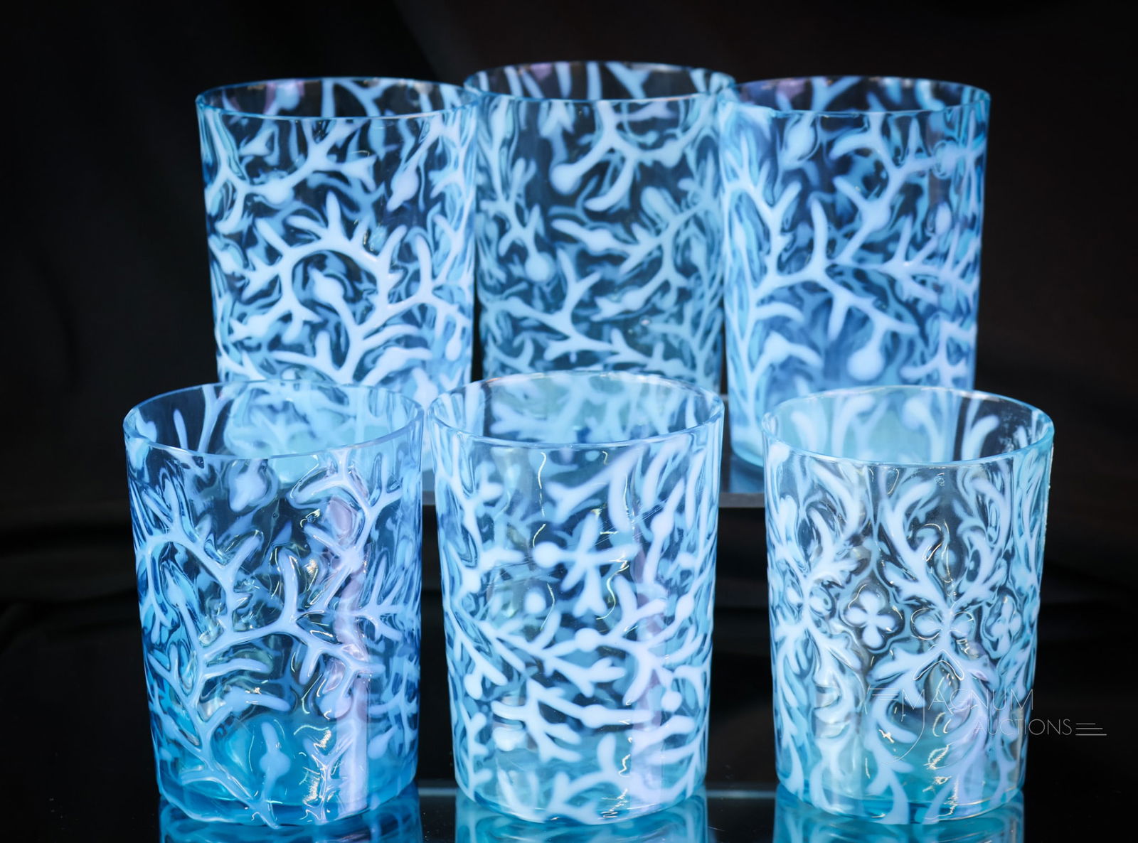 6 pc Blue Opalescent Victorian Glass Tumblers: Six finds in Victorian blue opalescent glass tumblers. This lot offers five Seaweed pattern and a single Spanish Lace. The tallest of the lot measures 3 3/4". Four of the Seaweed tumblers exhibit flak