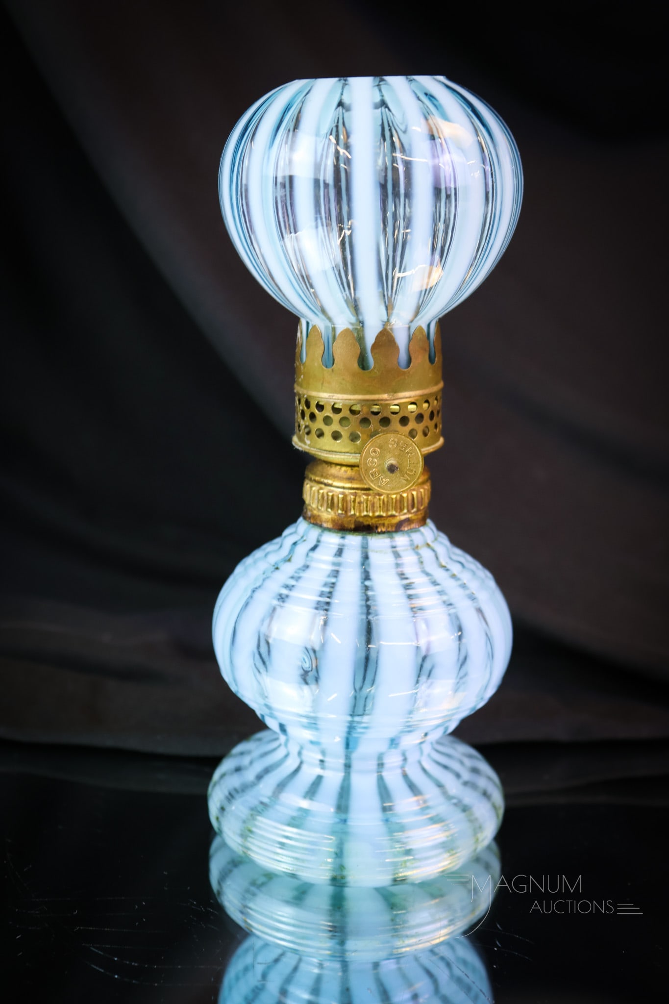 Victorian Blue Opalescent Glass Stripe Miniature Oil Lamp: A charming and scarce little Victorian miniature opalescent Stripe pattern oil lamp. This is a Waisted Rib Optic lamp. This little cutie measures only 6 1/2" tall. The glass of the base is horizontall