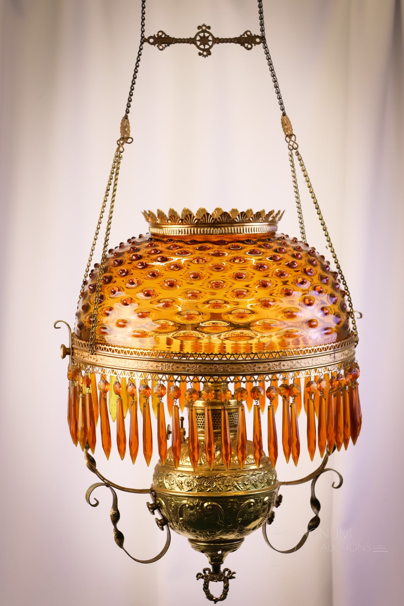 Victorian Amber Glass Hobnail Hanging Parlor Oil Lamp: Another nice find in our line-up of Victorian hanging parlor lamps. This lamp has an amber Hobnail pattern shade. The brass frame is quite nice, as well as the font. The lamp remains oil, and retains