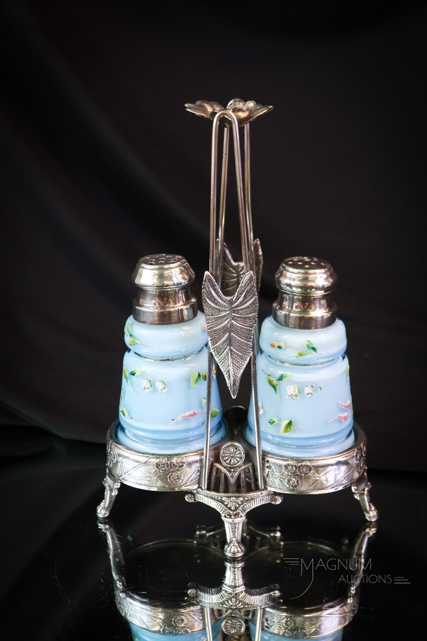 Rockford Silverplate Victorian Cased Enameled Glass Salt Shakers: A wonderful salt shaker set of the Victorian age. The holder is signed Rockford silverplate. The shakers are cased and enameled. Each features a creased design on the body. The set measures 8" tall. S