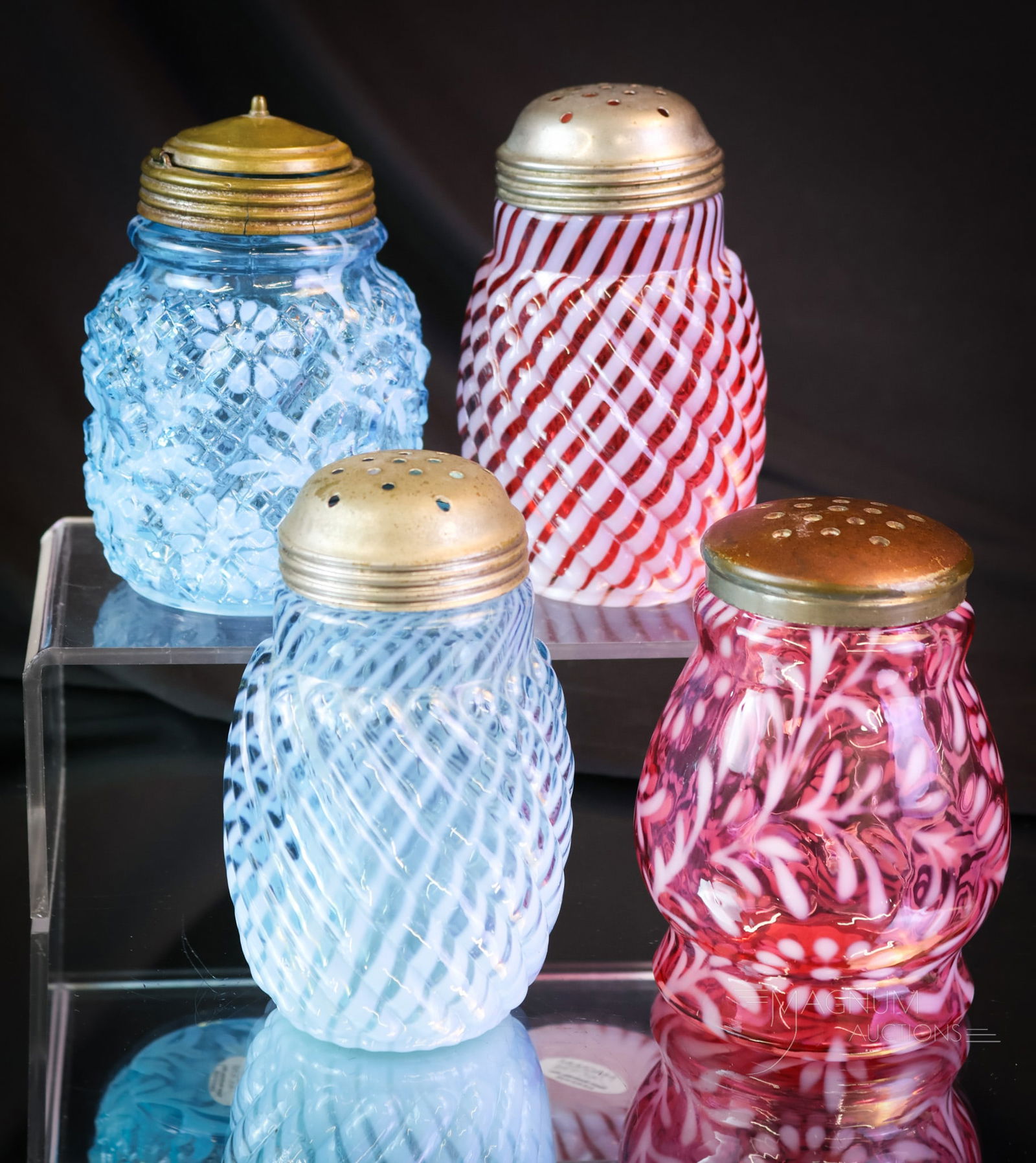 4 pc Lot Victorian Glass Opalescent Sugar Shakers: Four nice finds in Victorian opalescent glass sugar shakers. This lot includes a cranberry and blue sugar shaker in the Reverse Swirl pattern. There is also a cranberry opal Daisy & Fern in the Wide W