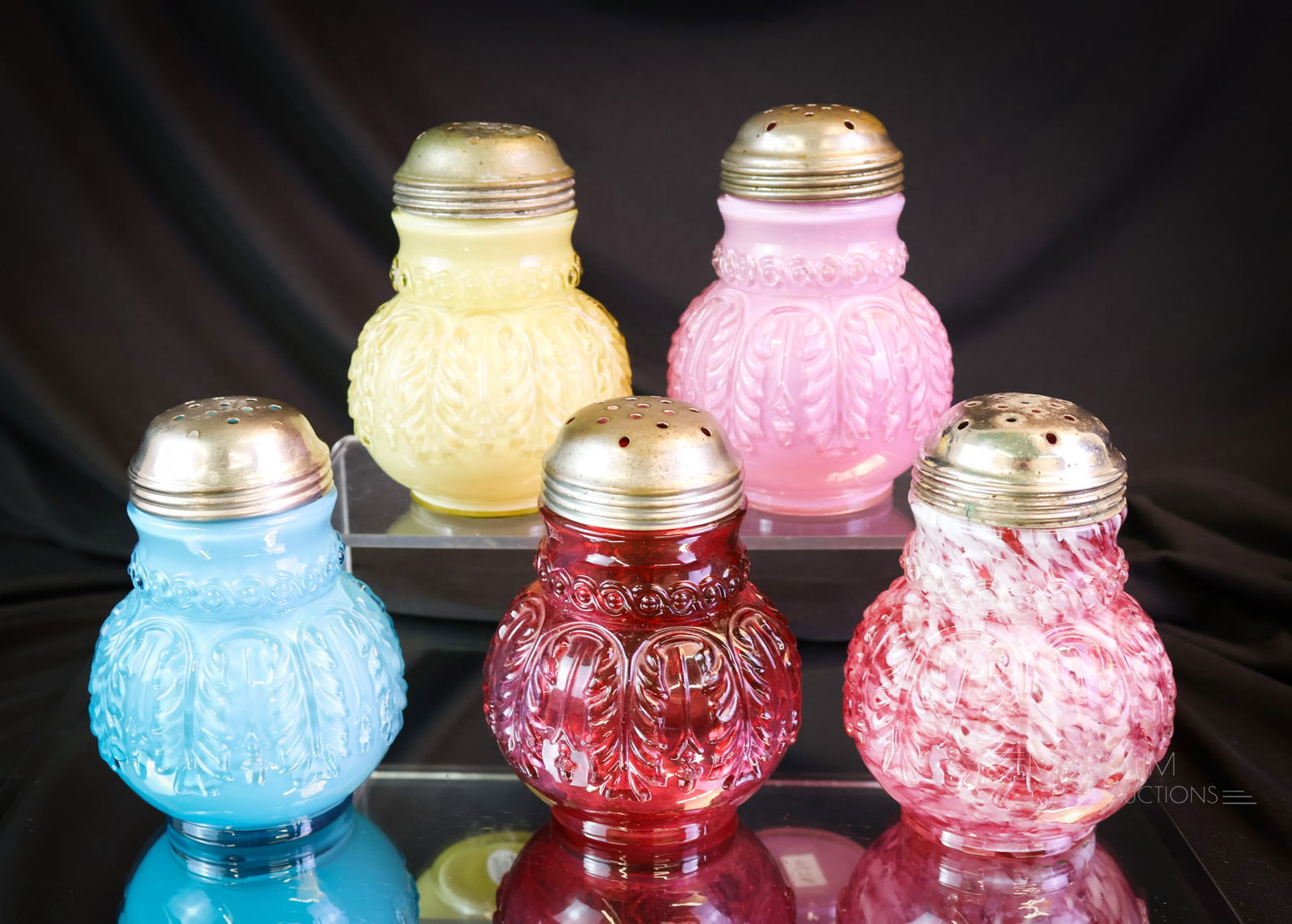 5 pc Lot Northwood Leaf Umbrella Victorian Glass Sugar Shakers: Variety is the spice of life. This lot includes five different colored examples of the Northwood pattern Leaf Umbrella. There is a cranberry, a blue, a yellow cased, a cranberry spatter, and lastly, a