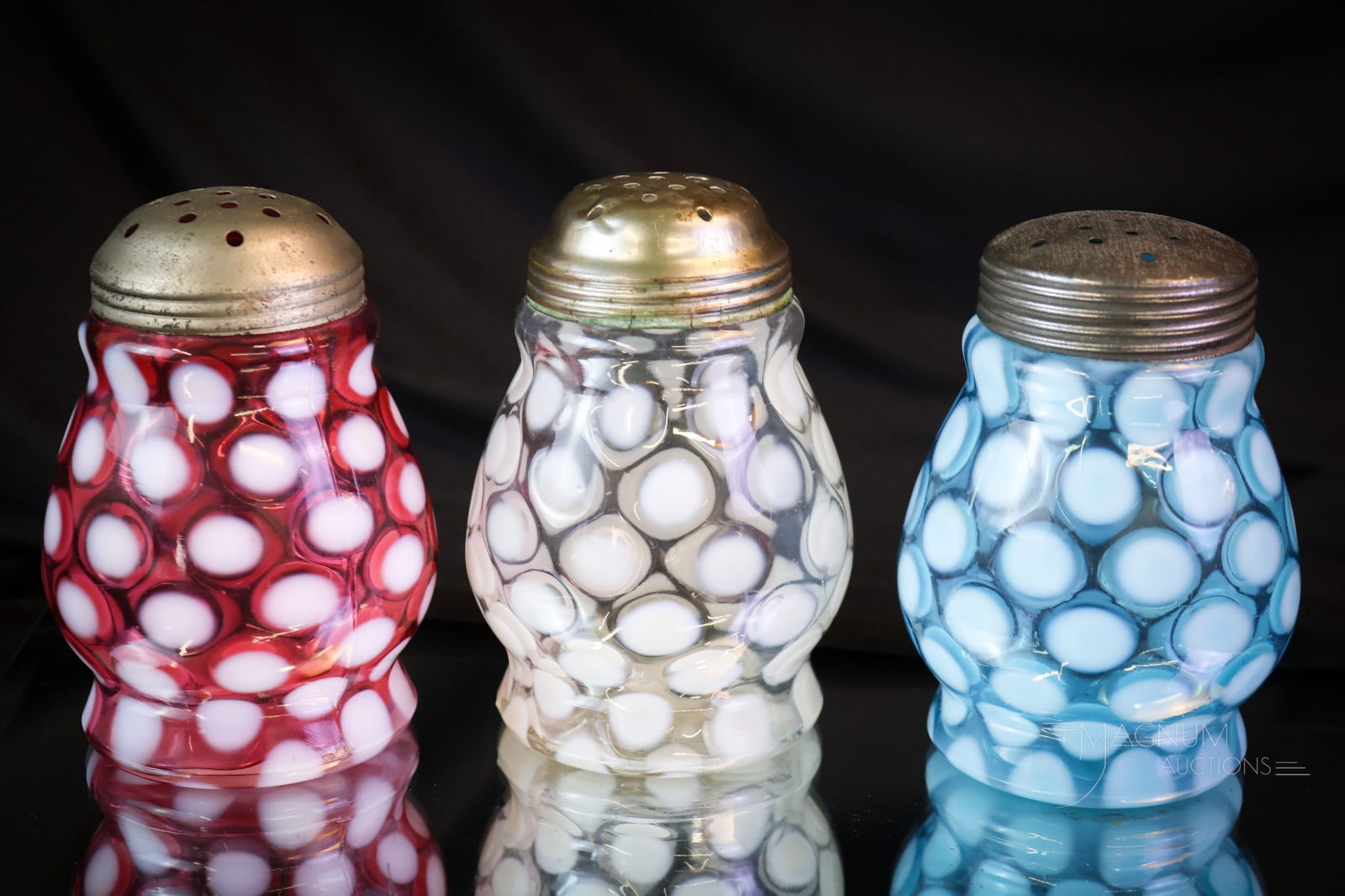 3 pc Lot Victorian Opalescent Glass "Patriotism In Sugar Shakers": Three fine examples of Northwood glass sugar shakers. These are all in the Wide Waist mold and Coinspot pattern. One in cranberry. One in white. The last in blue! Each measures 4 1/2" tall. SHIPPING N