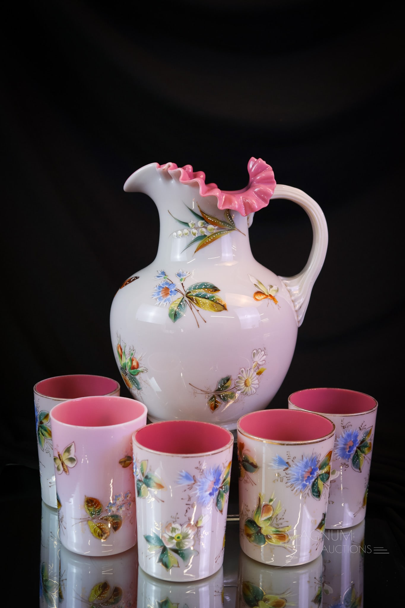 6 pc Peachblow Cased Victorian Enameled Glass Water Set: A great set in highly enameled Victorian cased peachblow glass. This set consists of a pitcher and five tumblers. The exterior of each piece is decorated with butterflies, moths, and wasps. The