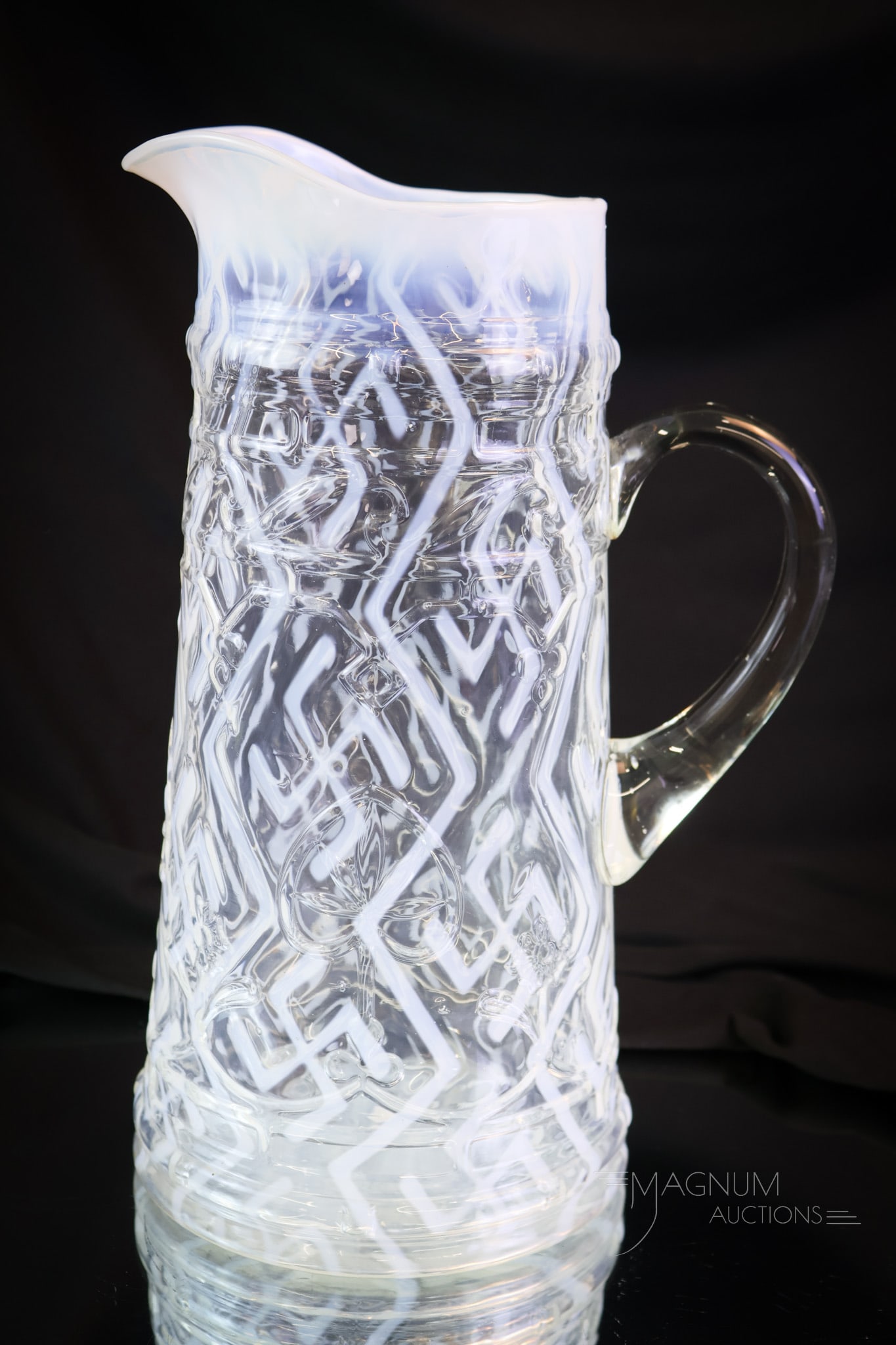Rare Victorian Northwood Opalescent Swastika Tankard Pitcher: A rare find in Victorian pitchers. This is a tankard in the Spades and Clubs mold. The opalescent pattern is Swastika. Such a rare find. Will you be the lucky new owner? The tankard measures 11"