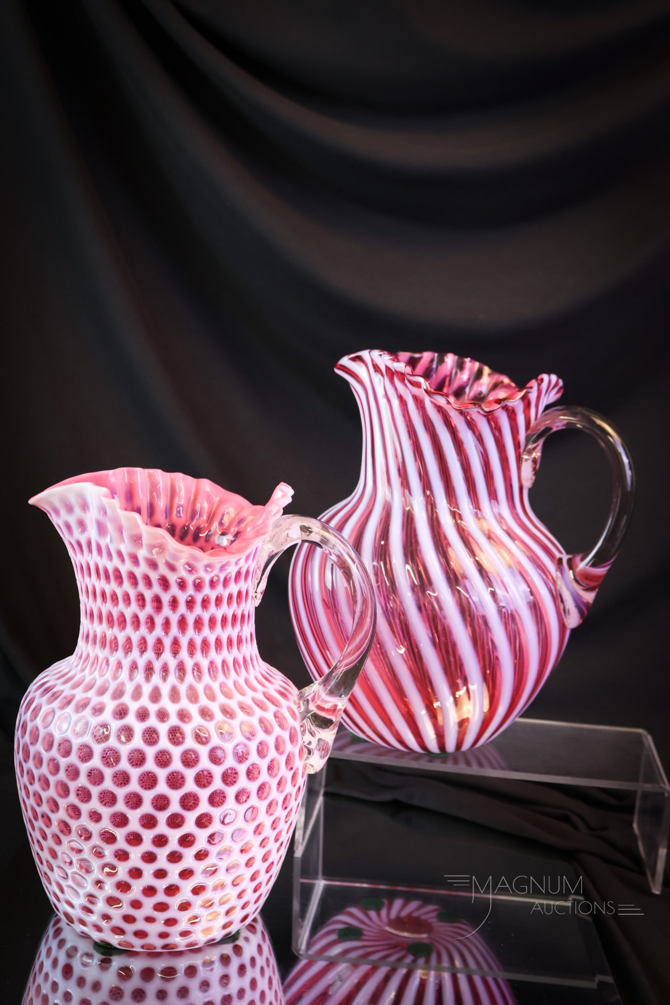 2 pc Lot Victorian Opalescent Glass Hobbs Water Pitchers: Two fine examples of Victorian Hobbs cranberry opalescent water pitchers. One is in the Swirl pattern. One is a Windows pattern example. The tallest measures 9". SHIPPING NOTICE: If you choose not to