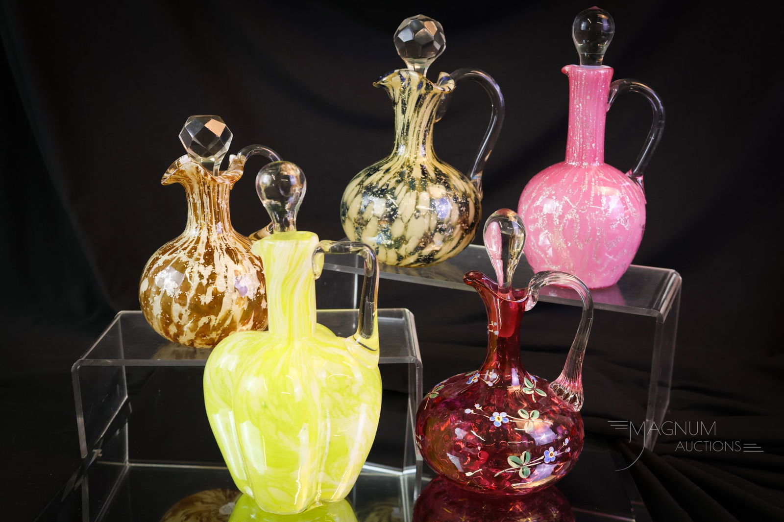 5 pc Lot Victorian Glass Cruets Spatter Cranberry Cased Phoenix & More: Five desirable finds in Victorian art glass cruets. This lot includes two cruets attributed to Phoenix glass with spatter and mica. There is also a cased mica Seaweed pattern. A yellow spatter lobed b