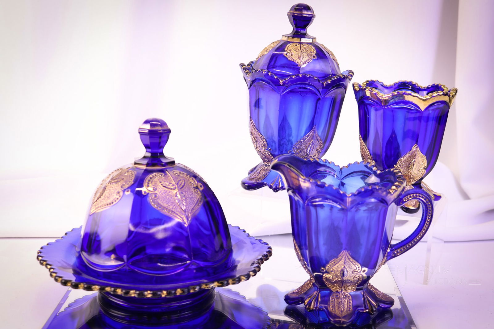4 pc Northwood Leaf Medallion Regent Cobalt & Gold Victorian Glass: A beautiful Northwood Regent or Leaf Medallion Victorian table set in cobalt with gold. This super set has excellent coloring and gilt décor. The tallest measures 7 1/2". SHIPPING NOTICE: If you choo