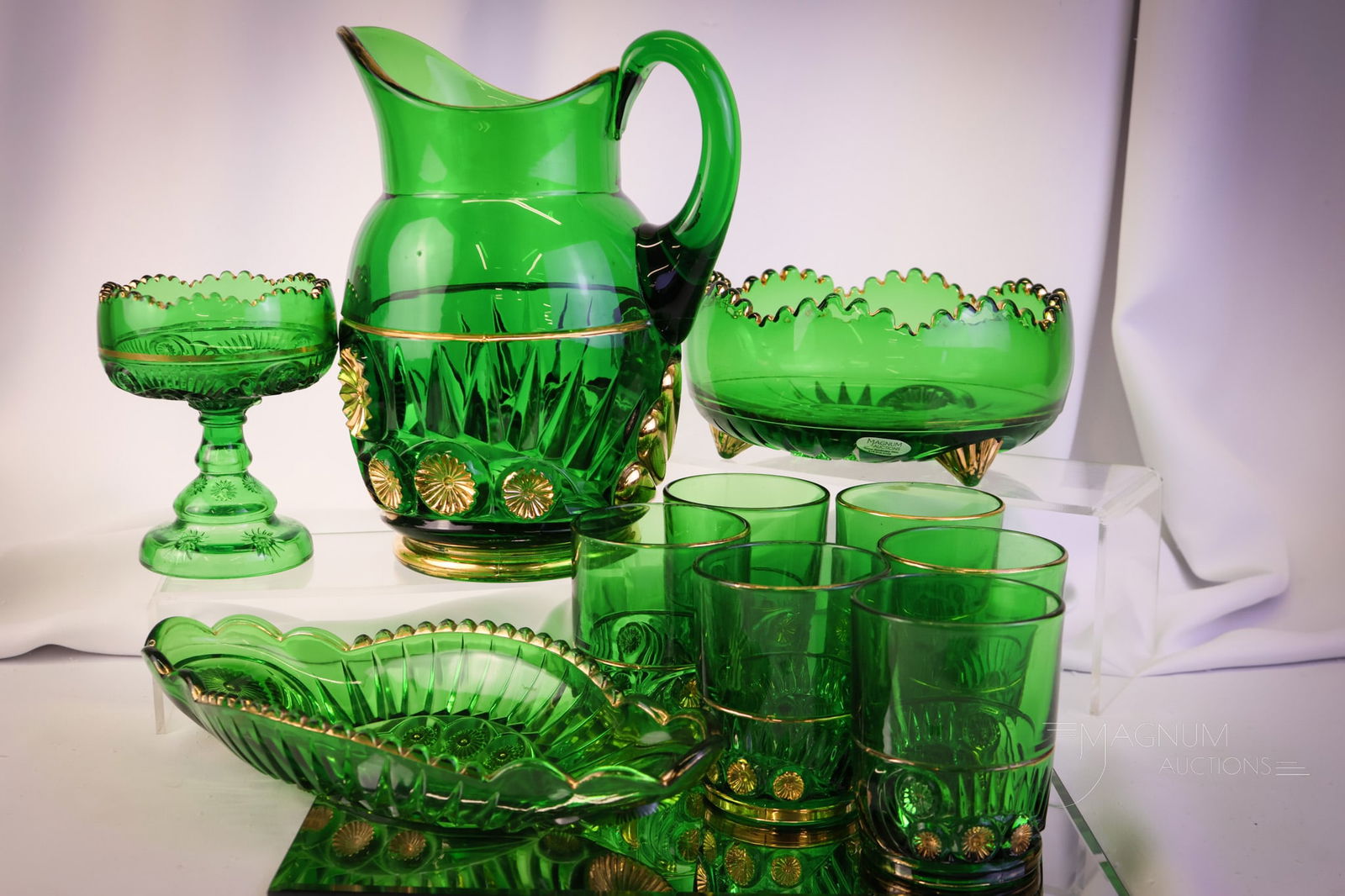 10 pc Lot Riverside Victorian Glass Green with Gold: Ten pieces of collectible Victorian Riverside glass in the Esther pattern. This lot includes a pitcher, six tumblers, a jelly compote, a large master berry bowl, and lastly, a relish tray. The tallest