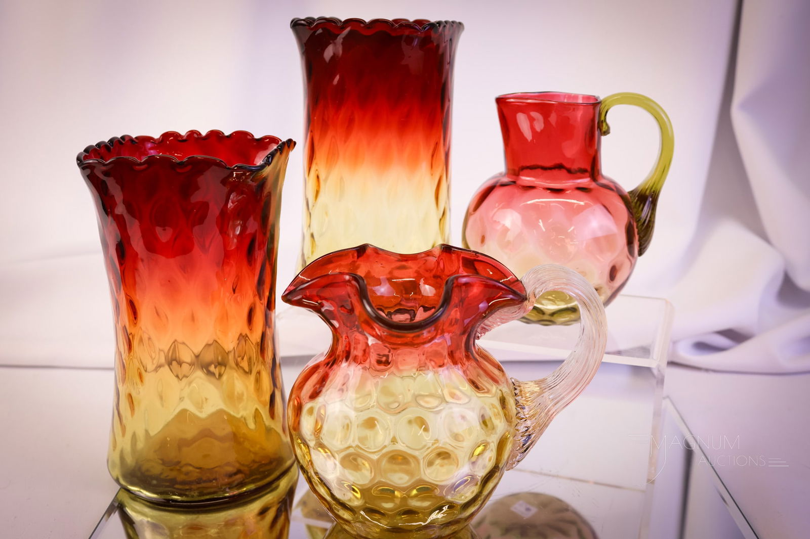 4 pc Lot Victorian Mt Washington & More Amberina Art Glass: Four delights for your bidding pleasure. This lot offers two diamond-quilt Mt. Washington celery vases and two cream pitchers. The tallest measures 6 1/2". SHIPPING NOTICE: If you choose not to utiliz