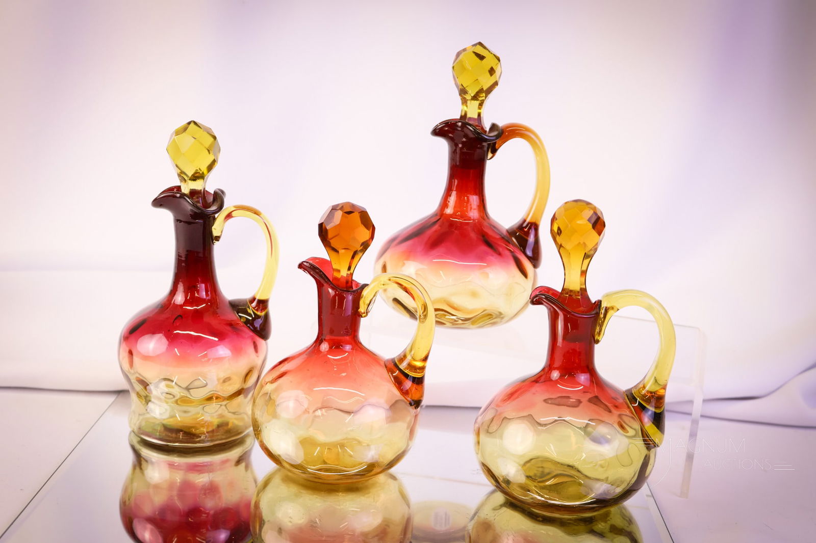 4 pc Lot Mt Washington & More Victorian Amberina Glass Cruets: This lot has so much to offer. There are two Mt. Washiognton glass cruets. One in the Lotus pattern and one in the Winchester pattern. There is also a pair of amberina Inverted Thumbprint glass exampl