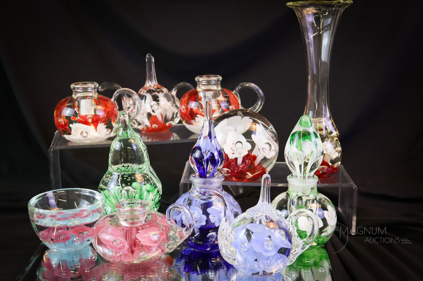 11 pc Lot St. Clair Paperweight Glass: Eleven divine pieces of St. Clair glass paperweight articles. This lot includes candle holders, perfumes, vases, and so much more. The tallest measures 8 1/4". SHIPPING NOTICE: If you choose not to ut