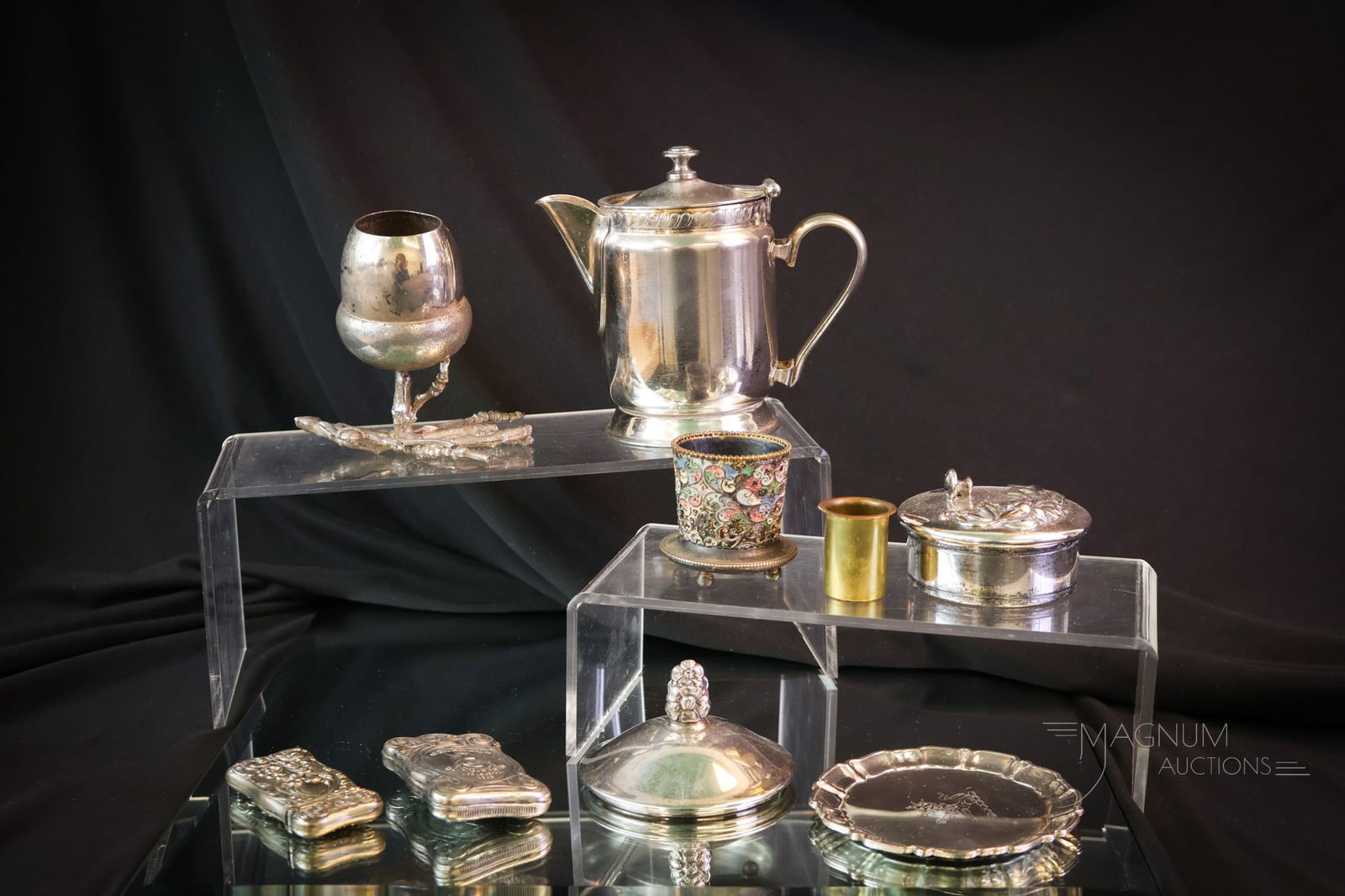 9 pc Lot Silverplate & Sterling: Nine finds to delight in silverplate from the Victorian era. This lot includes various forms and examples. One piece is a sterling repousse match safe. There is one match safe that's a Masonic, "Orien