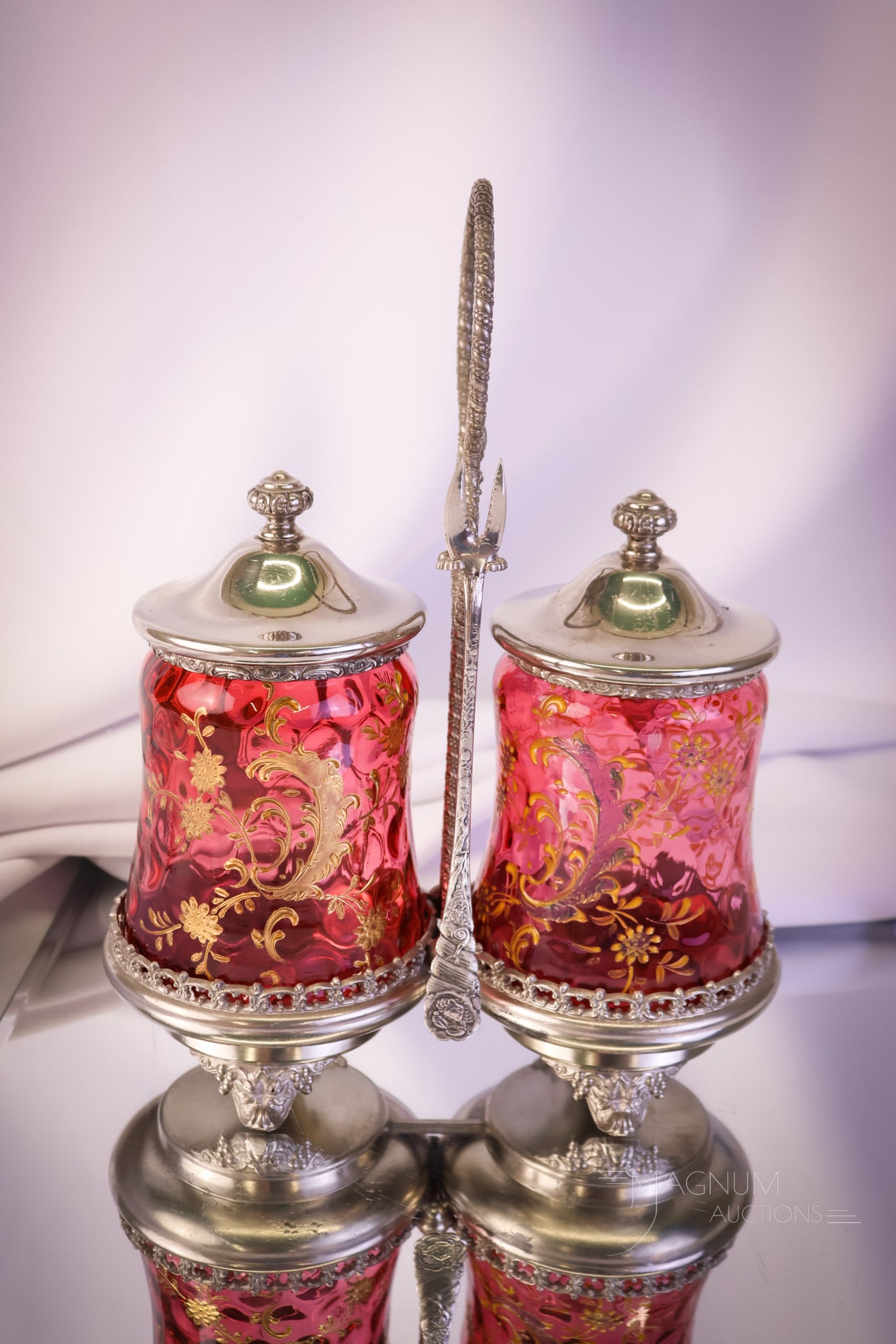 Forbes Silverplate Victorian Cranberry Enameled Double Pickle Castor: A super find in a Victorian pickle castor. The frame is signed Forbes. It embraces two cranberry enameled glass pickle jars. A rare ind for your collection. Make sure to bid on this one. The castor me