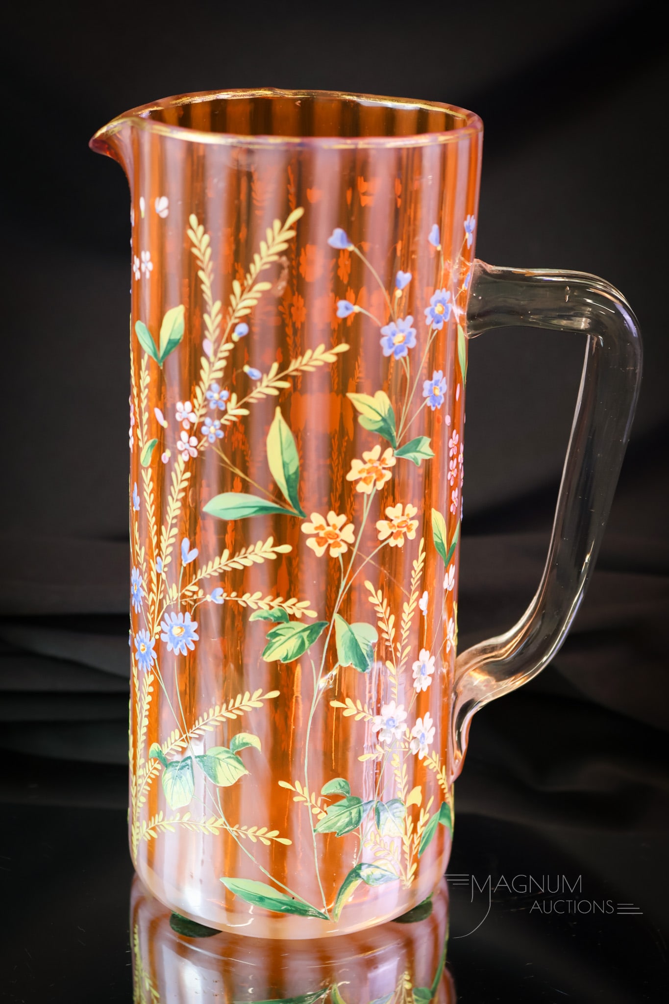 Rare Bittersweet Orange Opalescent Enameled Victorian Glass Tankard Pitcher: A rare find in Victorian art glass. This is a tankard-style pitcher in seldom found bittersweet orange opalescent glass and in the stripe pattern. The pitcher is lavishly decorated with enameled flora