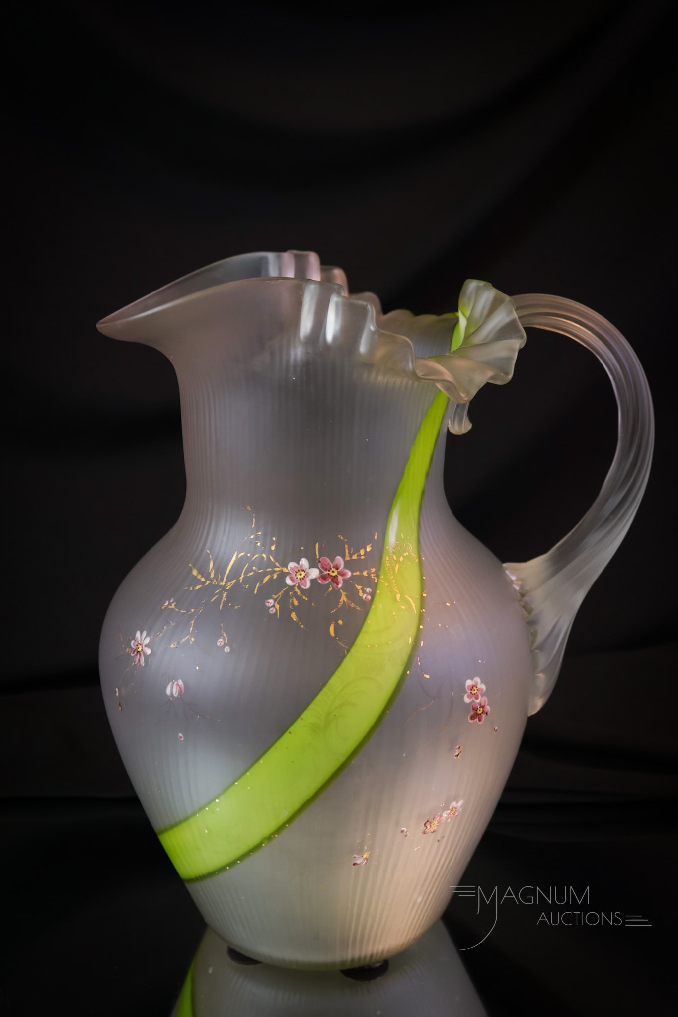 Scarce Victorian Harrach Olive Streak Gilt & Enameled Glass Water Pitcher: A scarce find in a Victorian attributed to Harrach art glass water pitcher. This fine example has a fine rib texture and an olive green swirl in the glass. It is gilt and enamel decorated. The pitcher