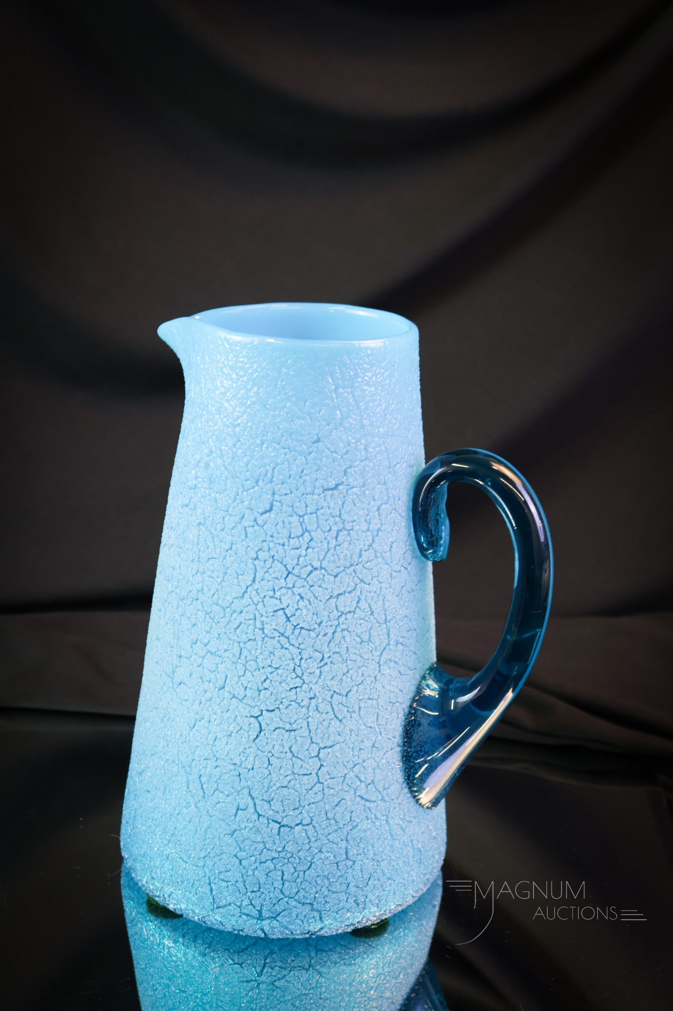 Scarce Reading Art Glass Victorian Overshot Opalescent Blue Tankard Water Pitcher: A scarce find in a Reading Artistic Glass Works Victorian pitcher. This piece has an overall overshot finish and deep ocean blue coloring, and an applied handle. The pitcher has an opalescence to it.