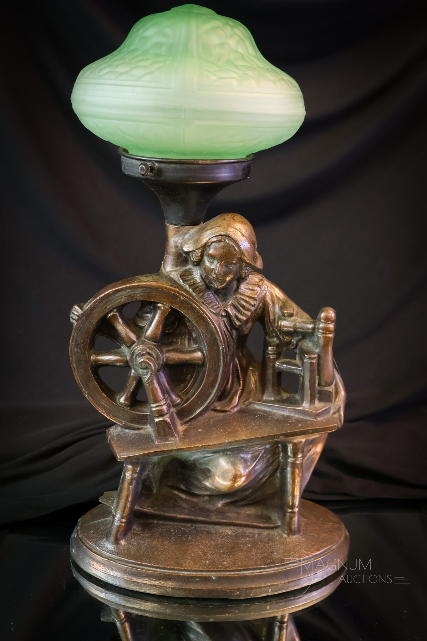 Art Deco Uranium Glass Dutch Woman Boudoir Lamp: A charming Art Deco period boudoir or radio lamp with uranium green glass shade. This nice find features a Dutch woman at a spinning wheel. The lamp measures 14 1/2" tall and 8" wide. SHIPPING NOTICE: