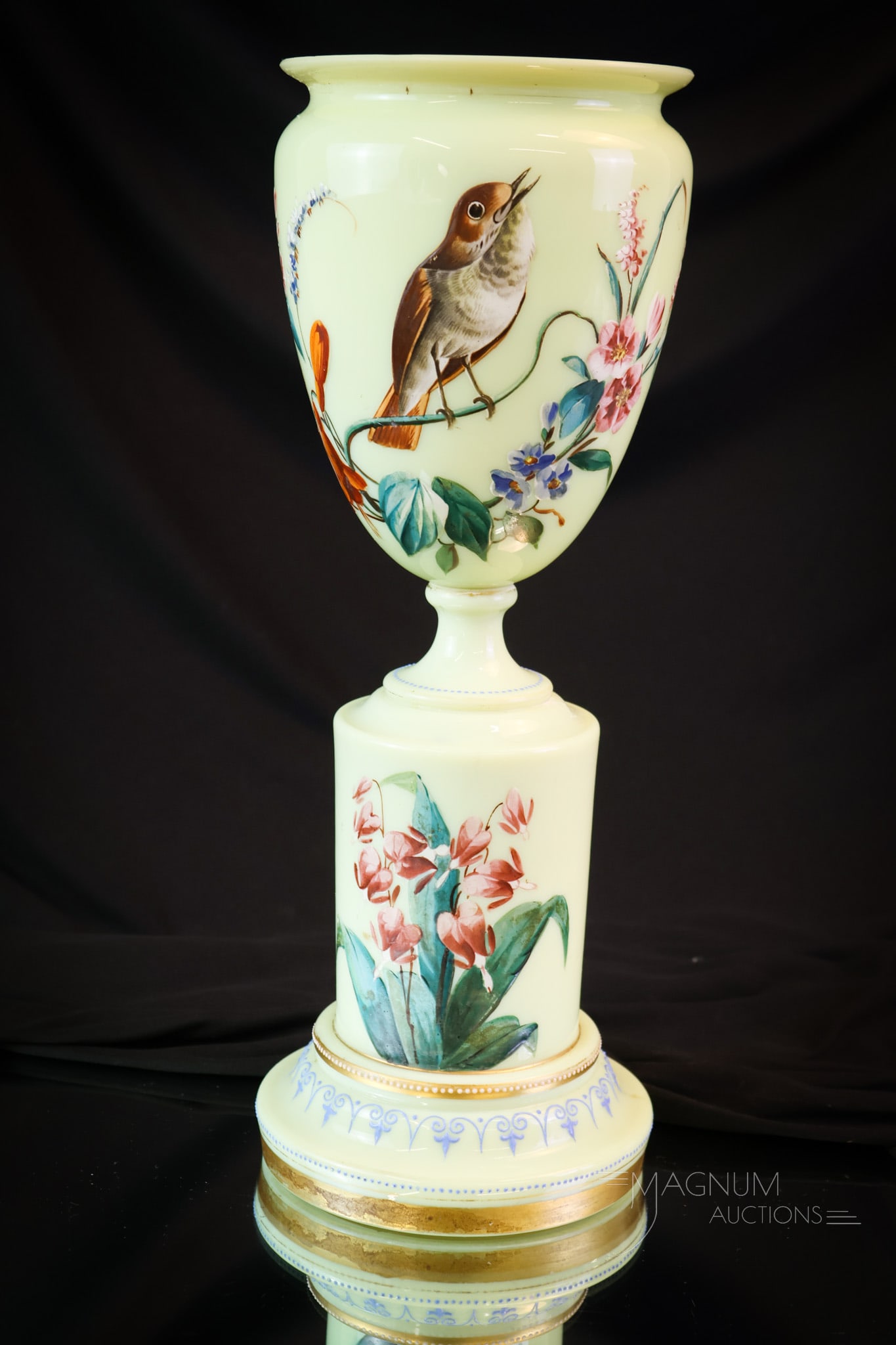 Uranium Custard Glass Enameled Victorian Glass Urn Vase: A uranium-rich Victorian glass pedetal urn form vase. This gorgeous find is lavishly decorated with enamel work of colorful flowers and a bird. The piece measures 14" tall. SHIPPING NOTICE: If you cho