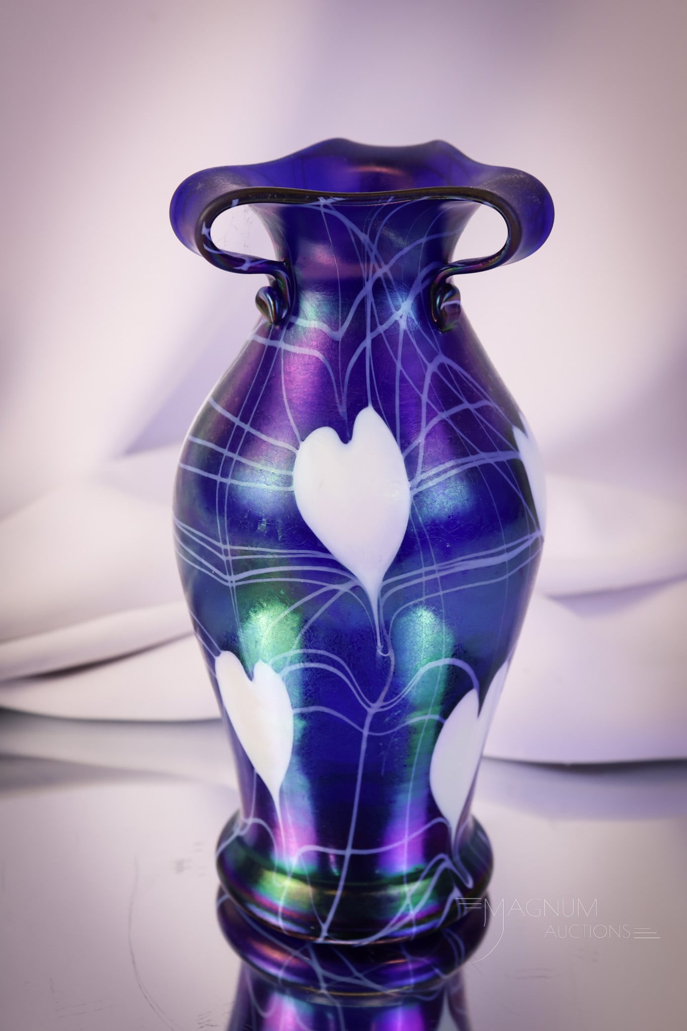Imperial Freehand Cobalt Iridescent Rabbit Ears Heart & Vine Vase: An impressive Imperial freehand cobalt iridescent rabbit ears vase with vivid white heart and vine decoration. This super example measures 8 1/2' tall. SHIPPING NOTICE: If you choose not to utilize th
