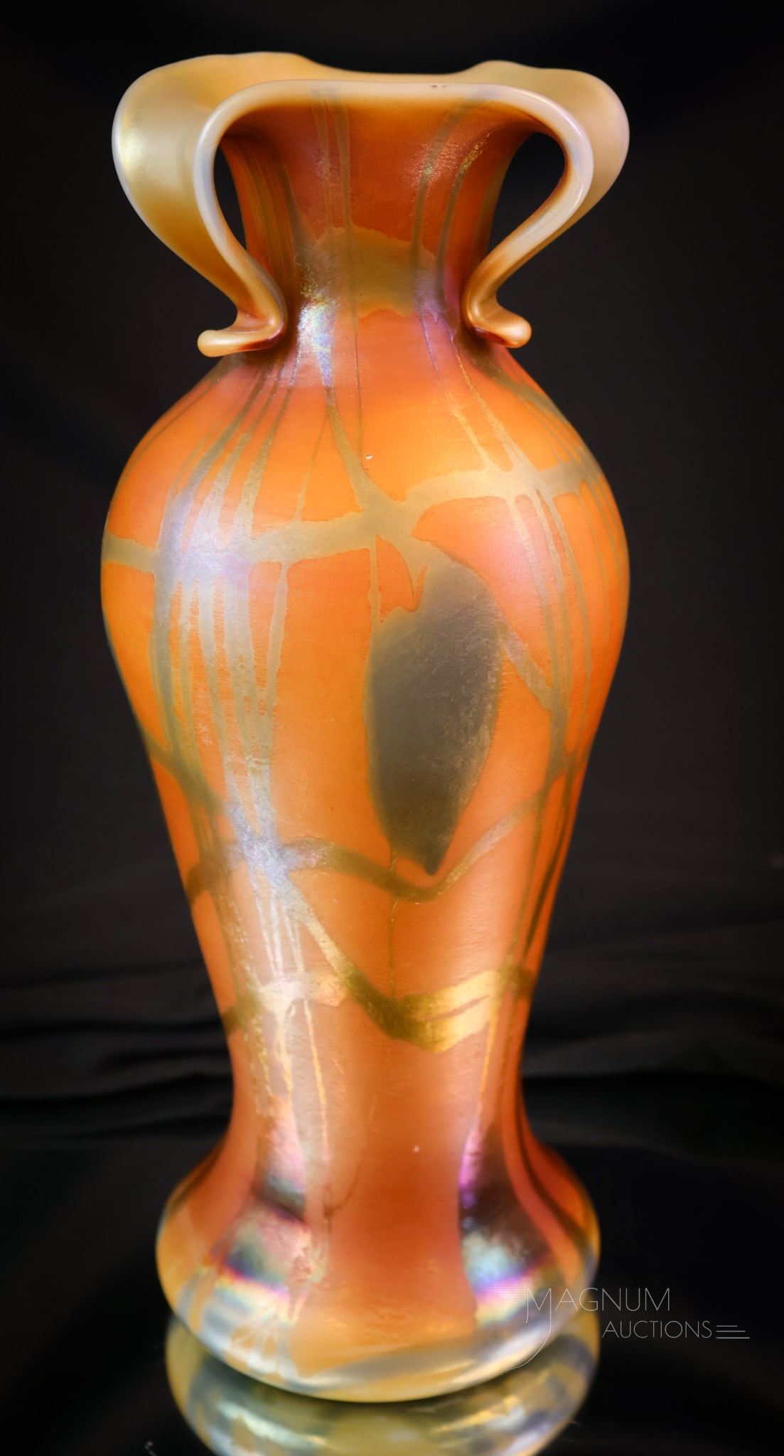 Imperial Freehand Orange Iridescent Heart & Vine Rabbit Ears Vase: A wonderful find in Imperial freehand art glass. This vase features an orange iridescent body and heart and vine decoration in deep blue. The top rim as a rabbit ear treatment. The vase features the o