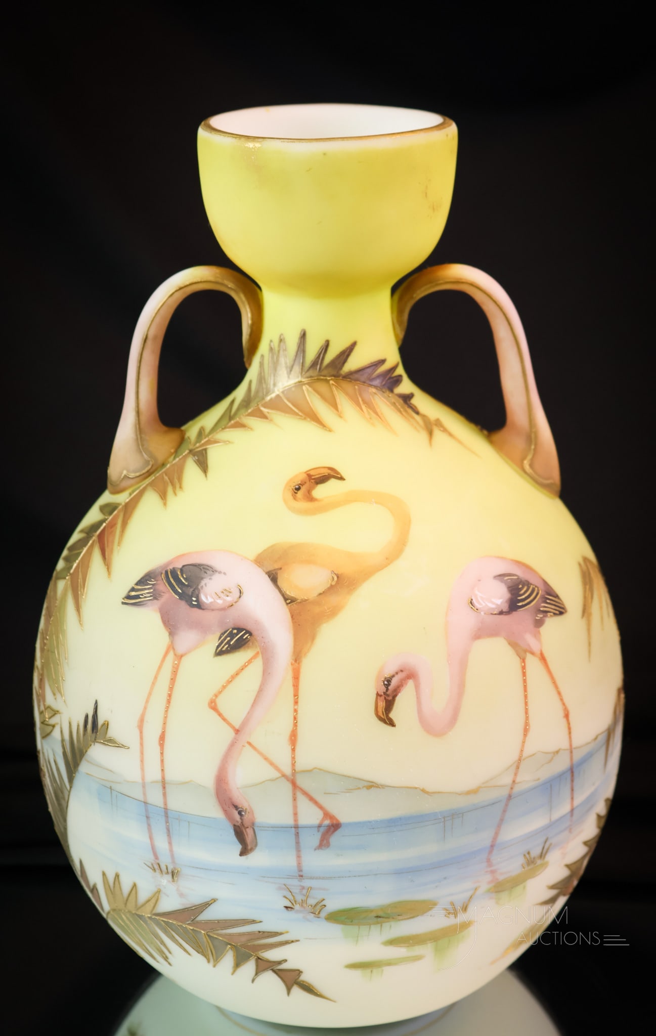 Mt. Washington Crown Milano Art Glass Flamingos Vase: A super find in Mt. Washington Art Glass. This is a Crown Milano decorated art glass vase. This piece has shrimp-pink flamingo birds on either side. The vase sports handles on either side of the neck.