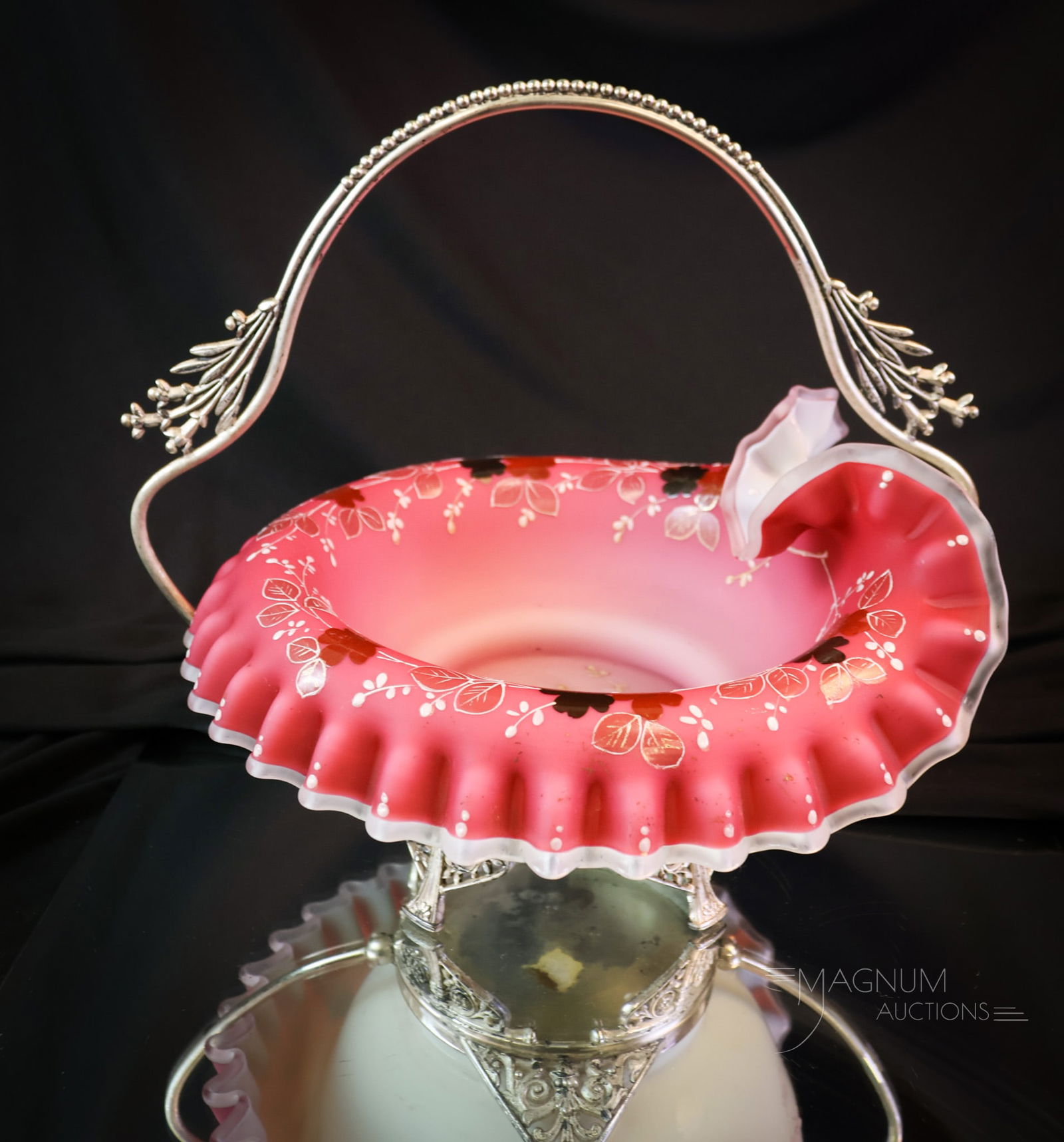 Meriden Silverplate Peachblow Decorated Art Glass Brides Basket: A Victorian Meriden silverplate brides basket, complete with an art glass peachblow bowl. This lovely example features a floral decoration. The piece measures 10" tall and 10 1/2" wide. SHIPPING NOTIC