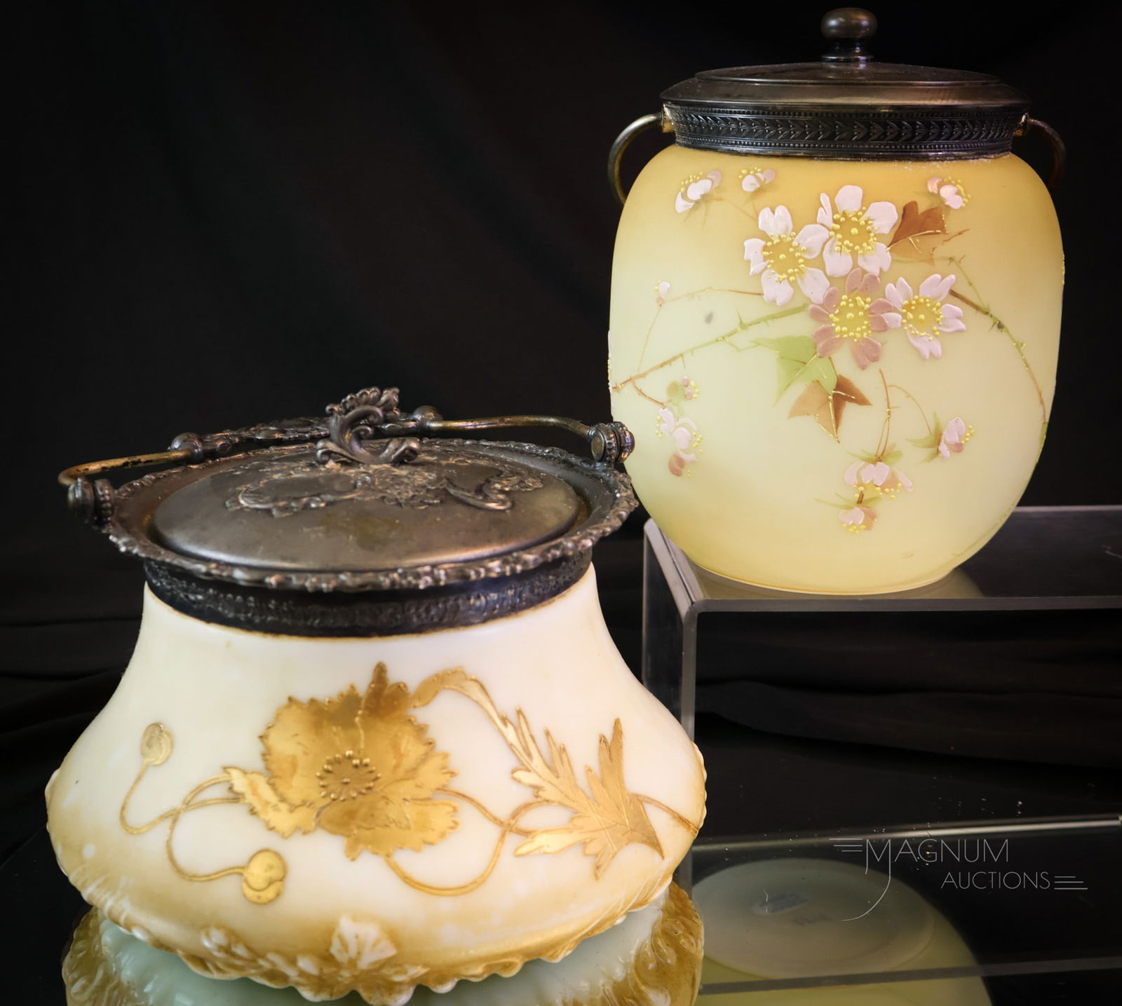 2 pc Lot Victorian Glass Pairpoint Mt. Washington Glass Biscuit Jars: Two wonderful finds in Victorian glass biscuit jars. The first is a Mt. Washington example in lustrless almond color with florals. The second is a Pairpoint white example with sand-colored ground and