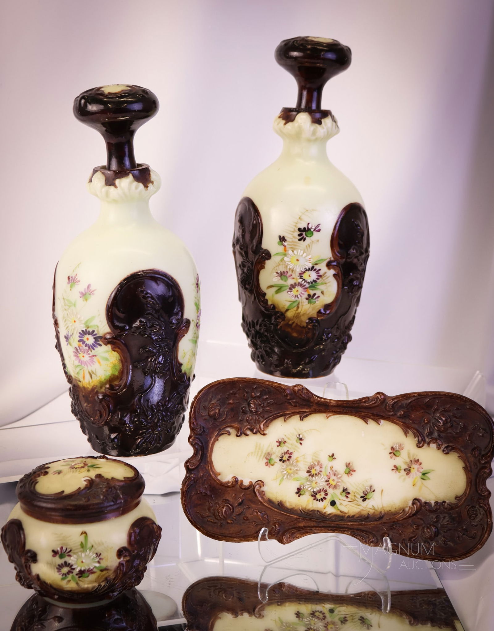 4 pc Victorian Chocolate Keystone Glass Dresser Vanity Set: A gracious four-piece Keystone Victorian enameled glass vanity set. This set includes two cologne bottles, a tray, and a puff box with a lid. The pieces are decorated with dark chocolate and vanilla c