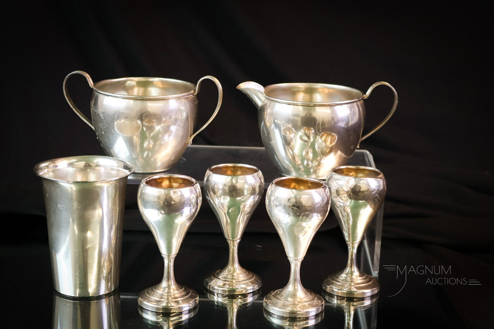 7 pc Lot Sterling Silver 7.177 OZT: Seven nice finds in sterling silver. This lot weighs 7.177 OZT. The lot includes a cream and sugar with a "C" monogram. They each have a few dents. There are also four cordials and, finally, a monogra