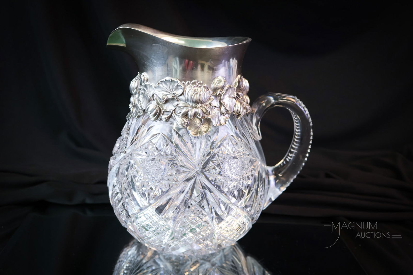 ABP American Brilliant Period Cut Glass marked Sterling Repousse Pitcher: A wonderful find in American Brilliant Period Cut Glass. This fine pitcher is in a Hobstar, Fan, and Diamond Cutting. This excellent find features a marked sterling repousse top with embossed water li