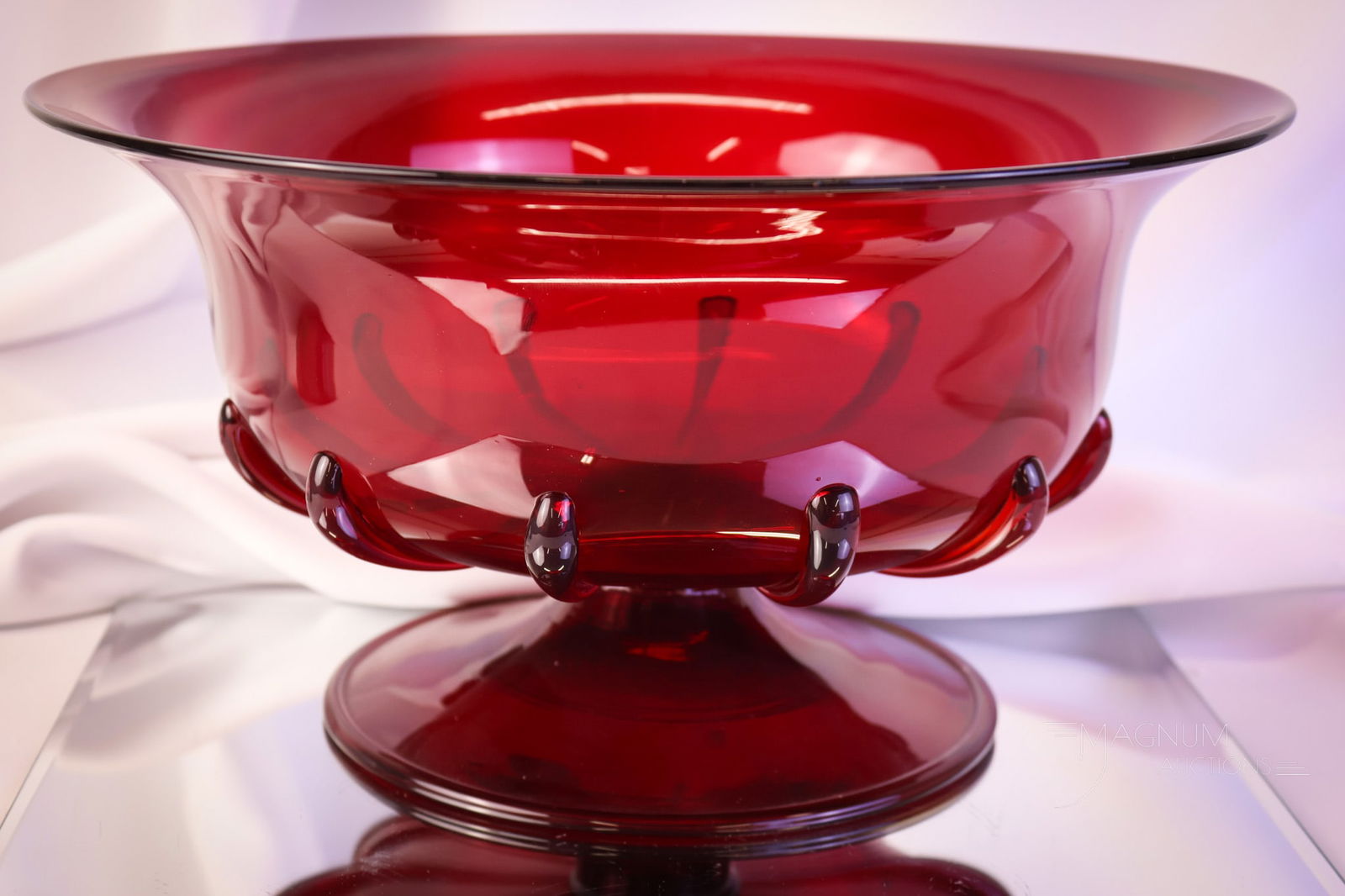 Steuben Selenium Red Art Glass Console Bowl: Here's a fine Steuben art glass Selenum red footed flared console bowl. This piece has applied tendrils around the body. The bowl measures 6 1/4" tall and 12" wide. SHIPPING NOTICE: If you choose not
