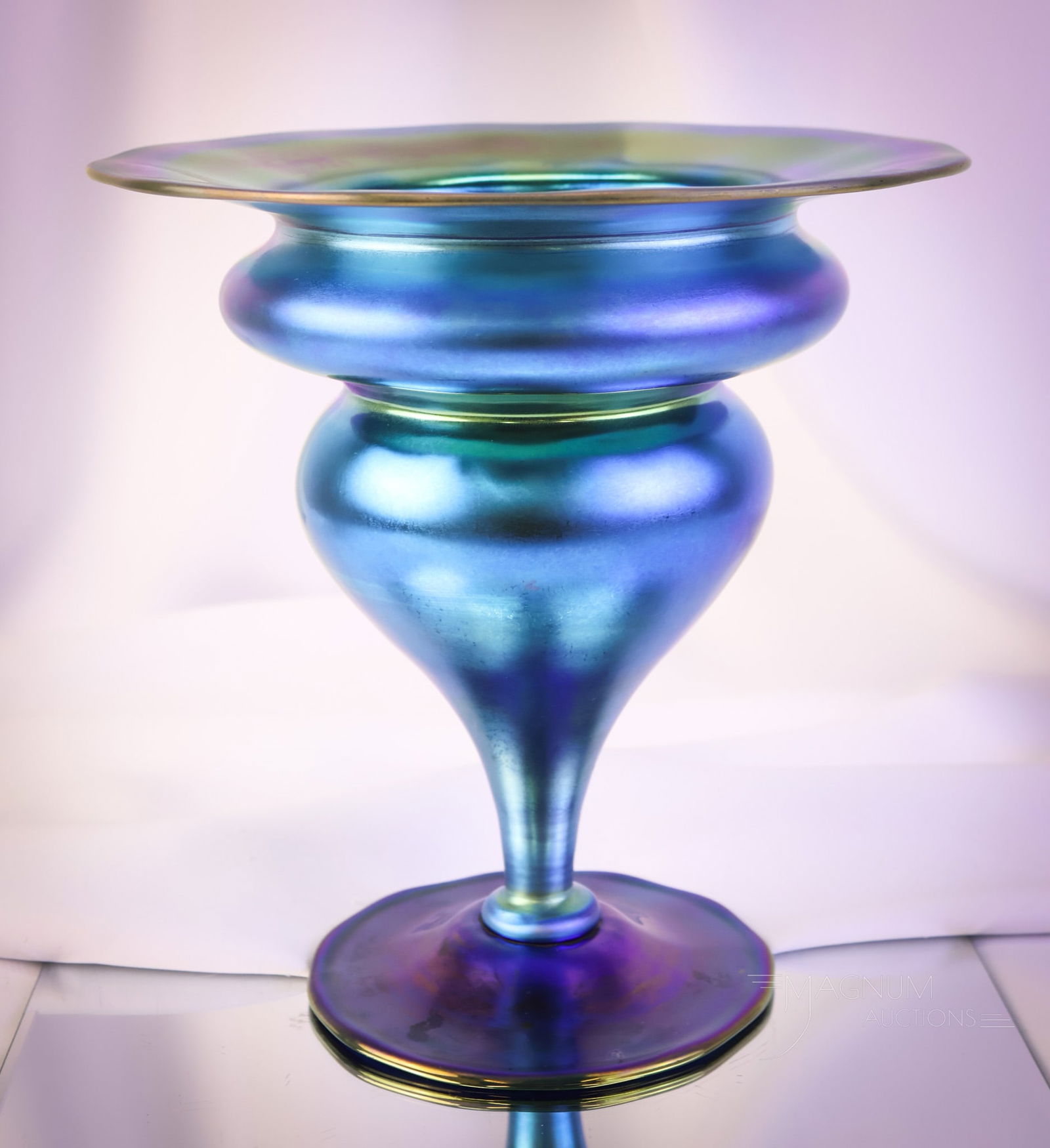 Steuben signed Blue Aurene Footed Art Glass Vase: A killer find in Steuben blue Aurene art glass. This pedestal-footed vase features a flared rim. The color is extraordinary. The vase is signed "Aurene". The line number is illegible. The vase measure