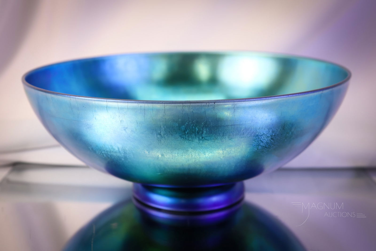 Steuben Blue Aurene #2852 Footed Bowl Art Glass: A brilliant electric blue Steuben art glass footed round bowl. This piece is marked "Steuben Aurene 2854." The bowl measures 3 1/2" tall and 9" in diameter. SHIPPING NOTICE: If you choose not to utili