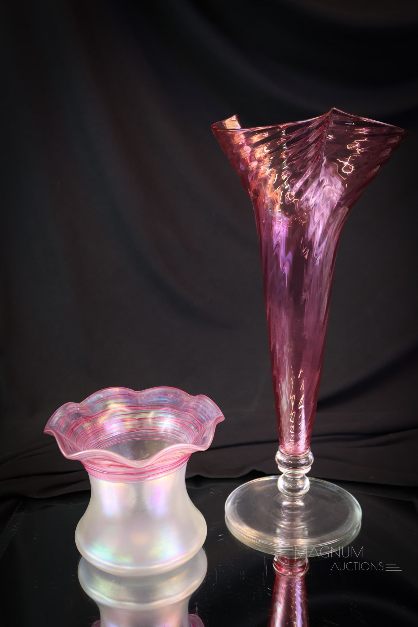2 pc Lot Steuben Art Glass Vases: Two fine examples of Steuben art glass vases. The first is a Gold Ruby swirl pattern vase. The second is a Verre de Soie vase with gold ruby threading. The tallest measures 11 3/4". SHIPPING NOTICE: 