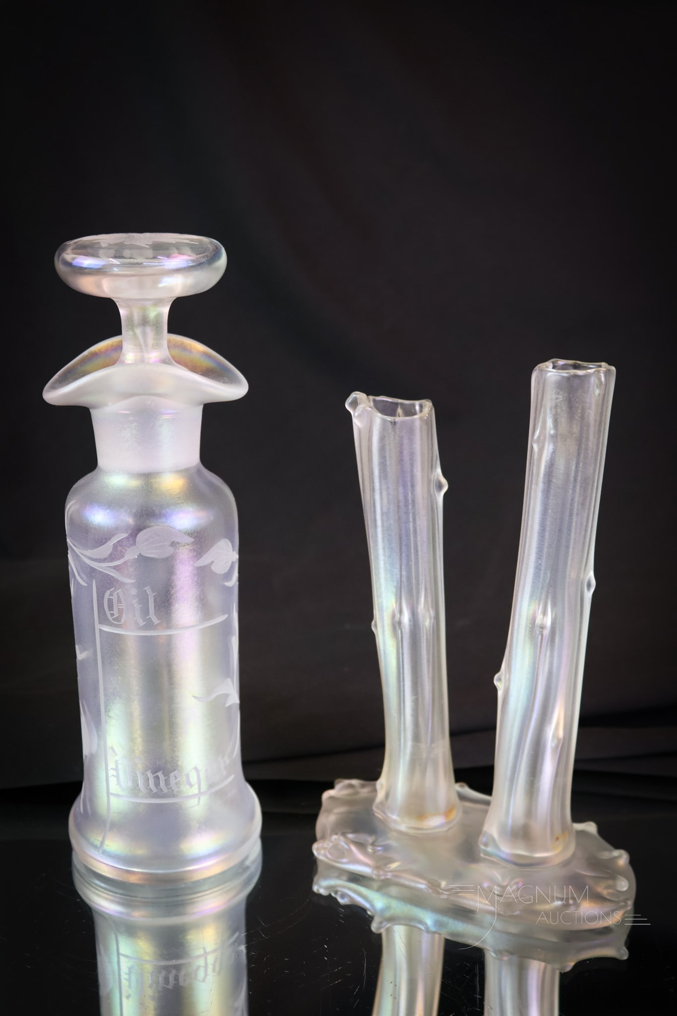 2 pc Lot Steuben Verre De Soie Art Glass: Two fine examples of Steuben Verre De Soie art glass. This lot offers a Hawkes cut oil/vinegar bottle and a Stump vase with double trunks. The tallest measures 7 3/4". A chip is noted on the base of t