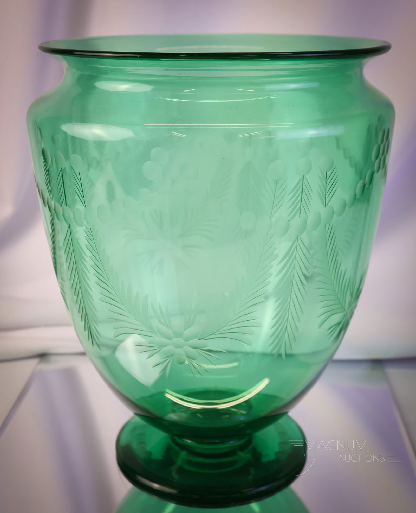 Steuben Pomona Green Engraved Uranium Art Glass Vase: A nice find for your collection. This is a Steuben Pomona Green pedestal form vase. This vase is engraved with floral wreaths. The glass is rich in uranium content and glows under black light. The vas