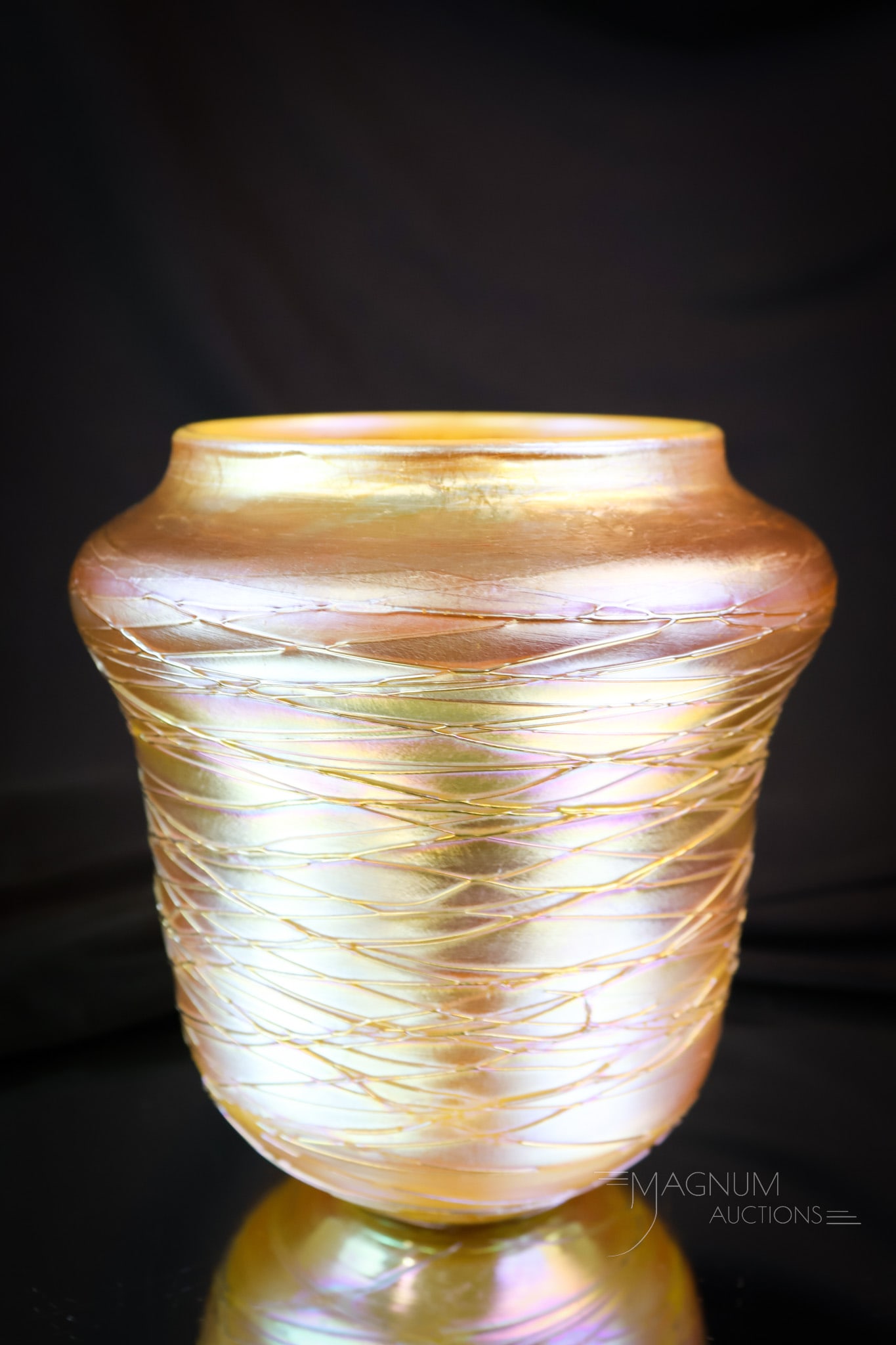 Durand Threaded Art Glass Vase: A beautiful vase attributed to Durand. This lovely example is in gold iridescent glass with a threaded glass overlay. The vase measures 5 3/4" tall. SHIPPING NOTICE: If you choose not to utilize the L