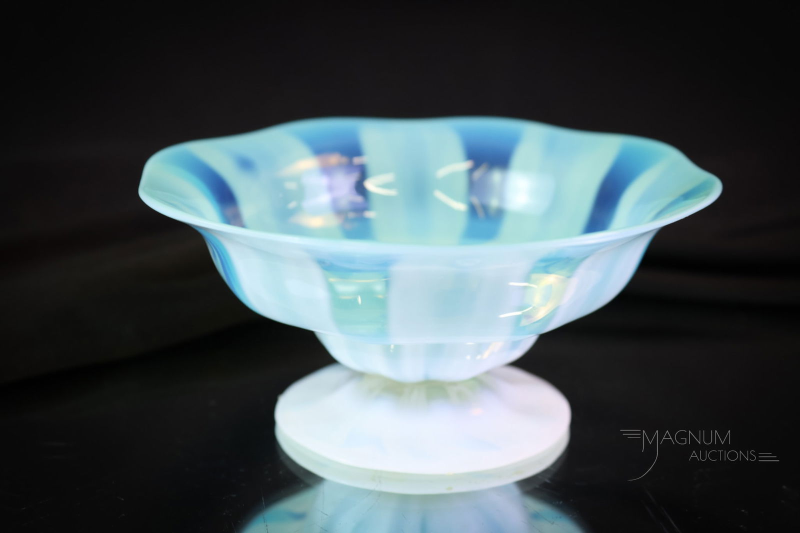 Tiffany signed Favrile Green Pastel Opalescent Art Glass Bowl: A charming find in signed Tiffany pastel opalescent art glass. This pedestal bowl in green opal opalescent rib pattern with an opalescent foot. The piece is signed "L.C.T. Favrile." The bowl measures