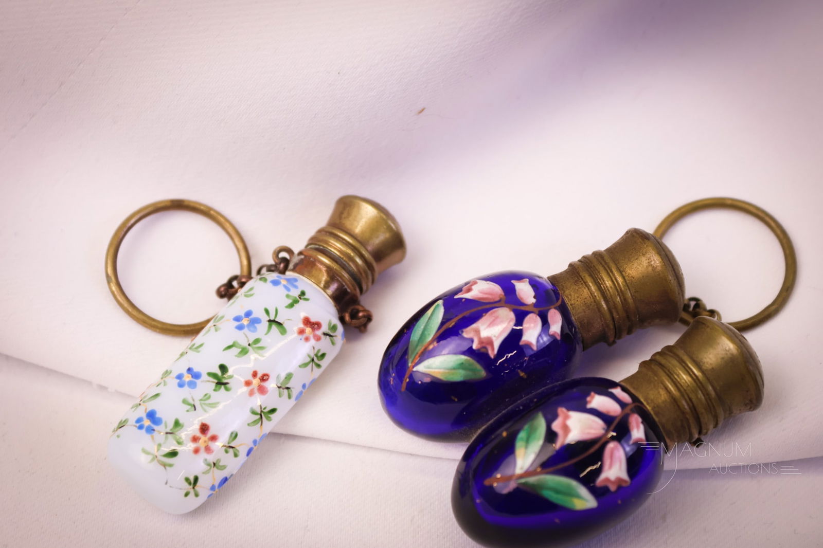 2 pc Lot Miniature Art Glass Perfumes: Two dainty little finds in art glass perfumes. The first is an opaline glass with enameled blue and pink flowers. This one has the original stopper, chain, and finger ring. The second is a cobalt glas