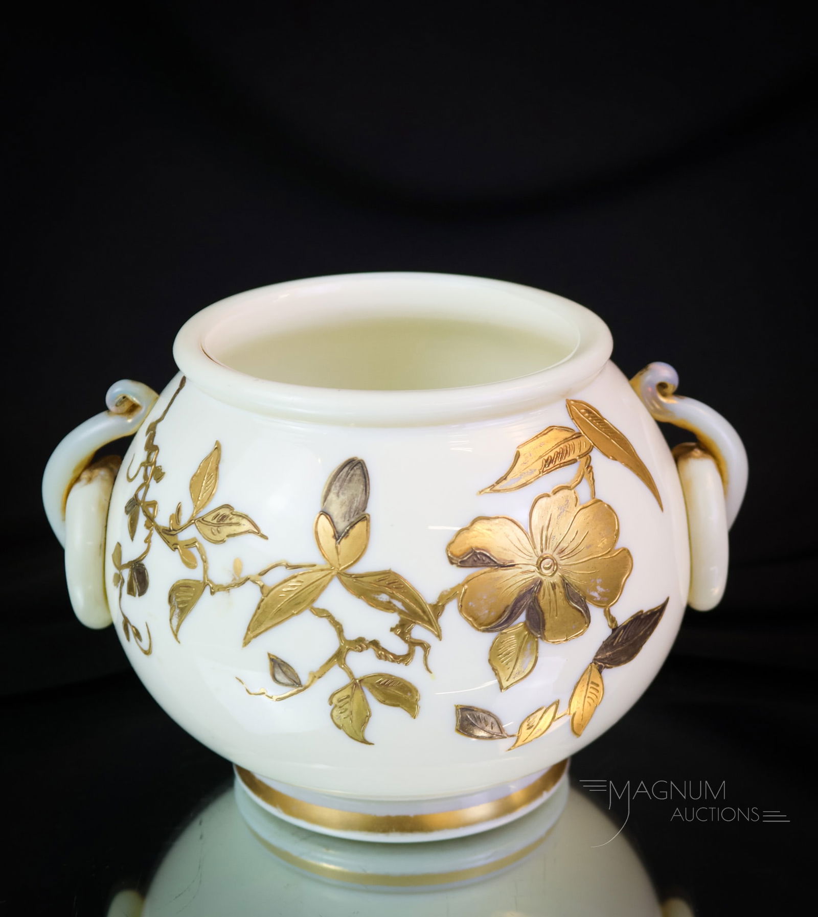 Webb Ivory Uranium Applied Art Glass Gilt Vase: A gorgeous and glowing find in Victorian Webb art glass. This vase is rich in uranium content and glows brightly under black light. The vase has applied glass handles and is decorated with gold enamel