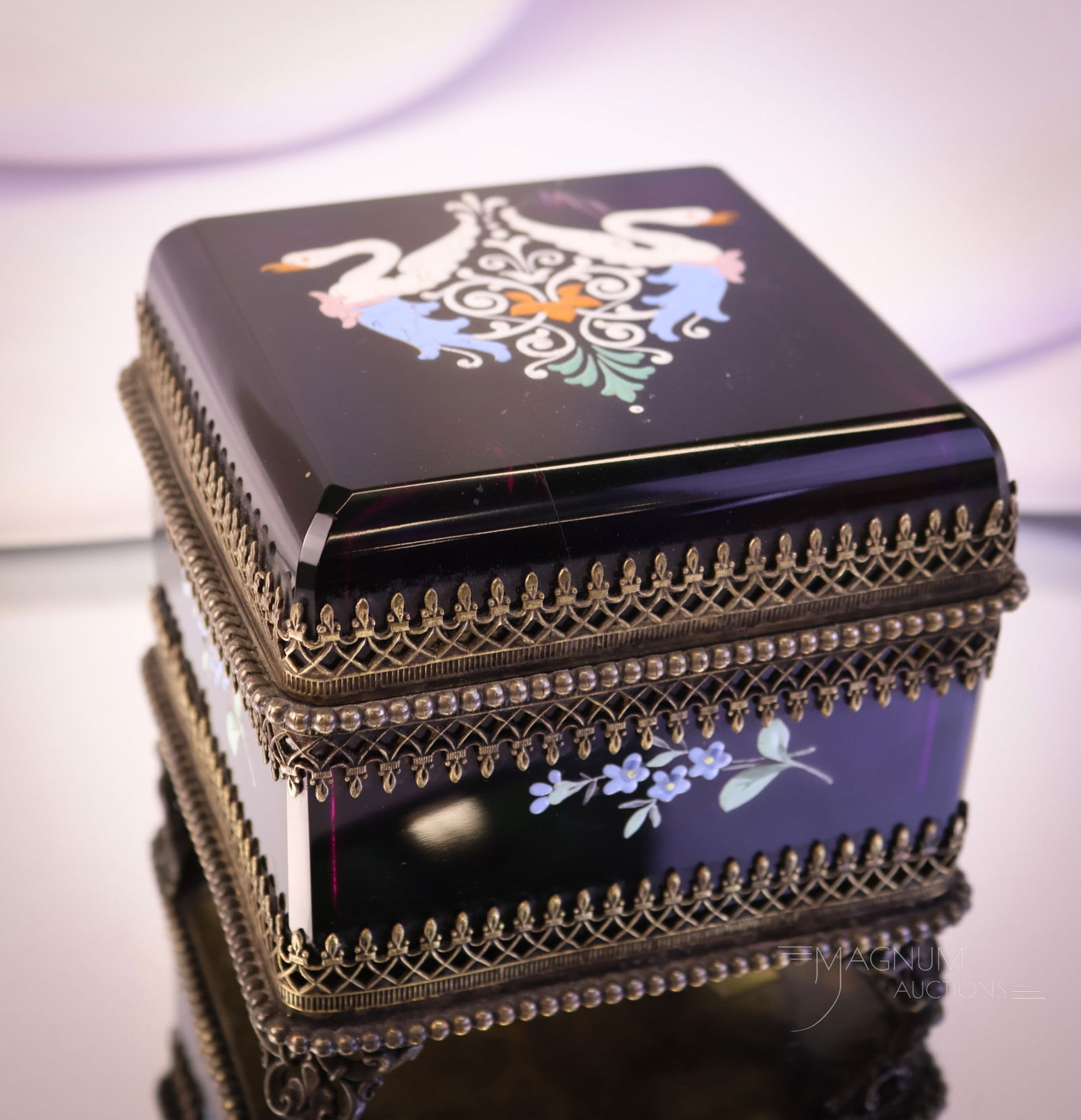 Amethyst Victorian Glass Jewelry Casket: A wonderful example of a Victorian enameled glass jewelry casket. This example is in amethyst glass with enameled swans and florals. This box measures 4" tall and 4 3/4" wide. The lid exhibits interna