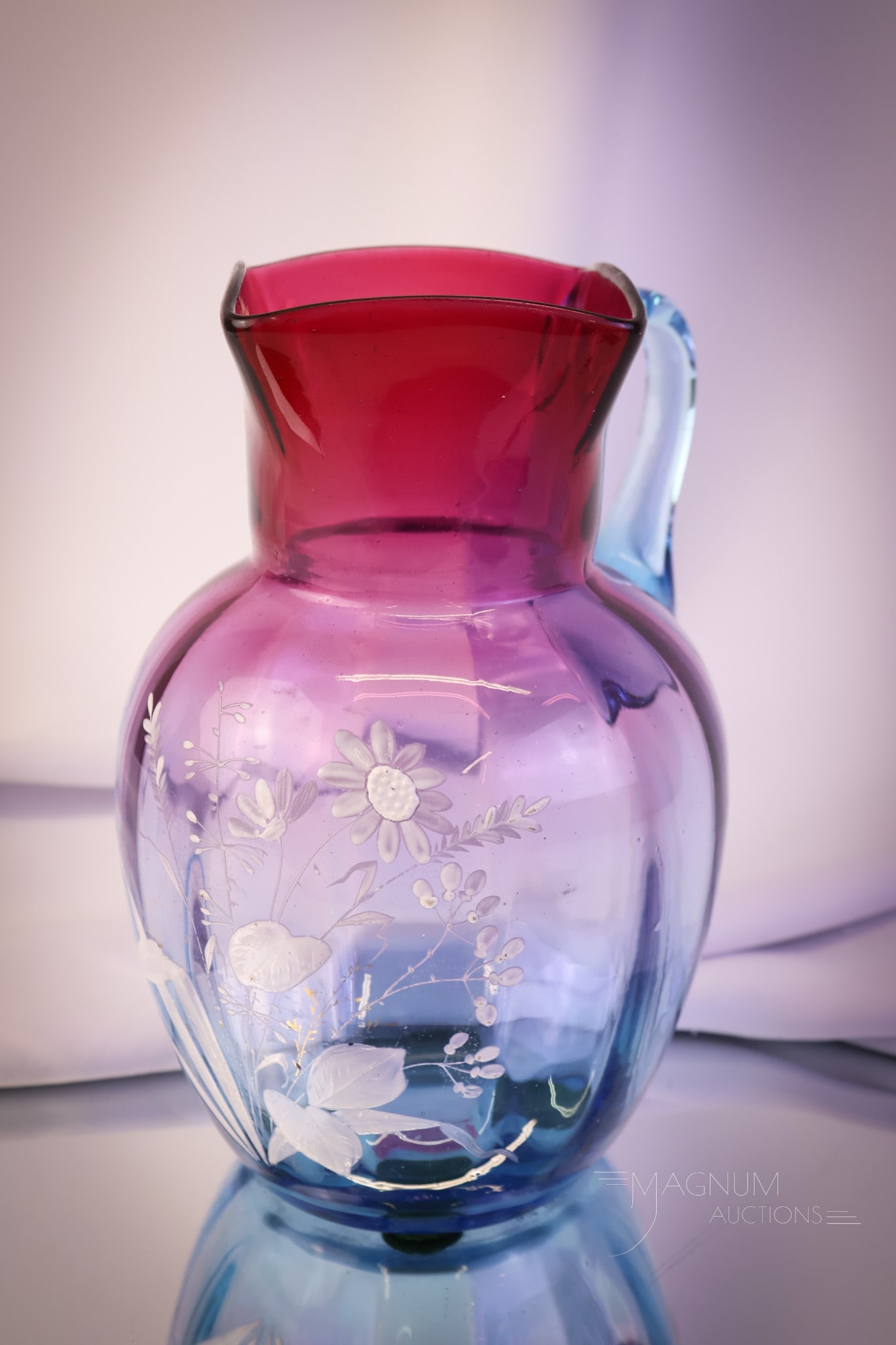 Bluerina Victorian cranberry to Blue Enameled Art Glass Water Pitcher: A gorgeous and rare find in a Victorian art glass water pitcher. This piece has extraordinary coloring, from brilliant blue to ruby cranberry. It is further embellished with enameled florals. The pitc