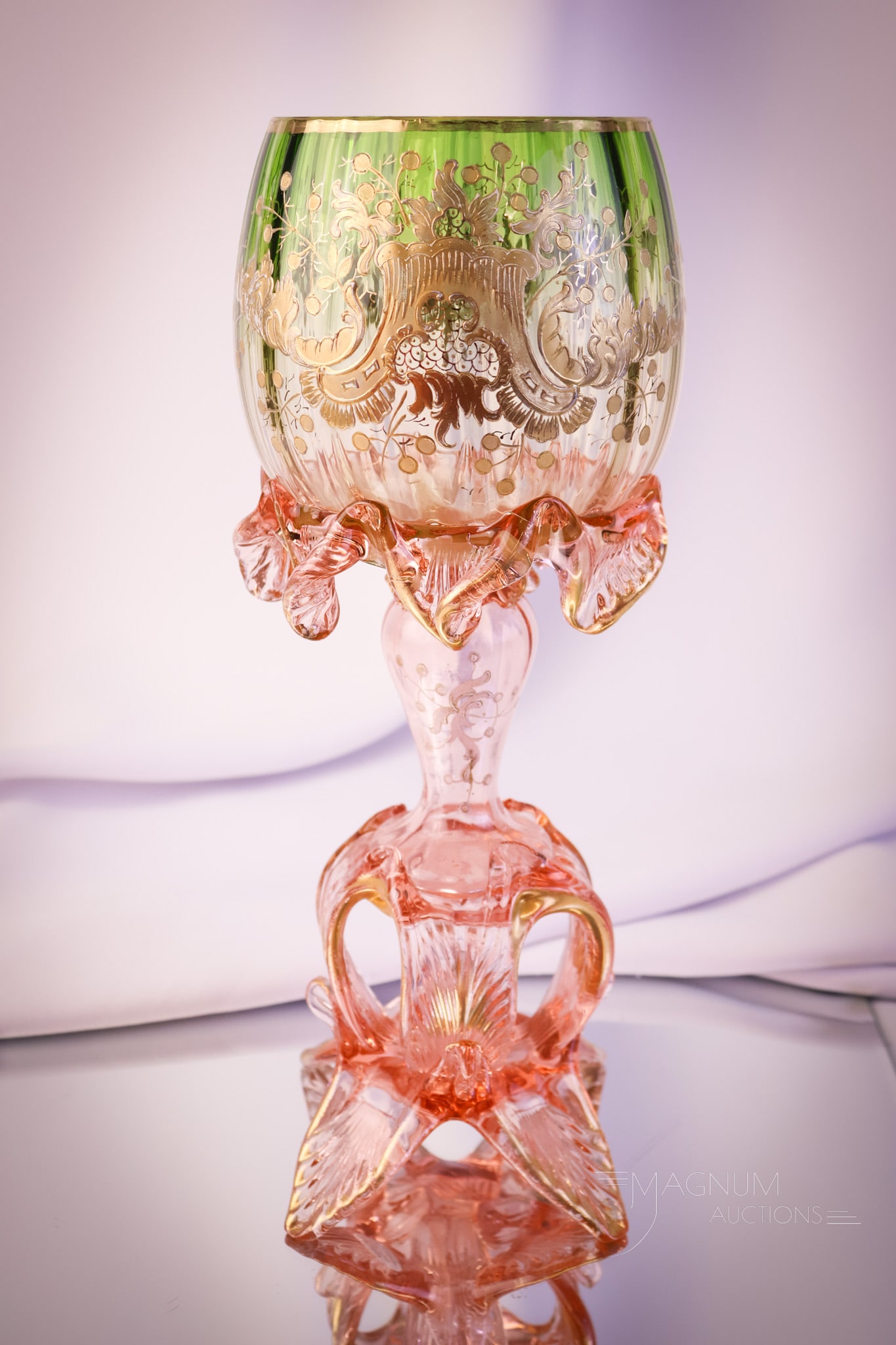 Moser Applied Art Glass Gilt Chalice: A beautiful find in Victorian Moser attributed art glass. This chalice has a pedestal form with an applied petal form foot and a shaded green bowl. The piece is decorated with gold and enamel work. Th