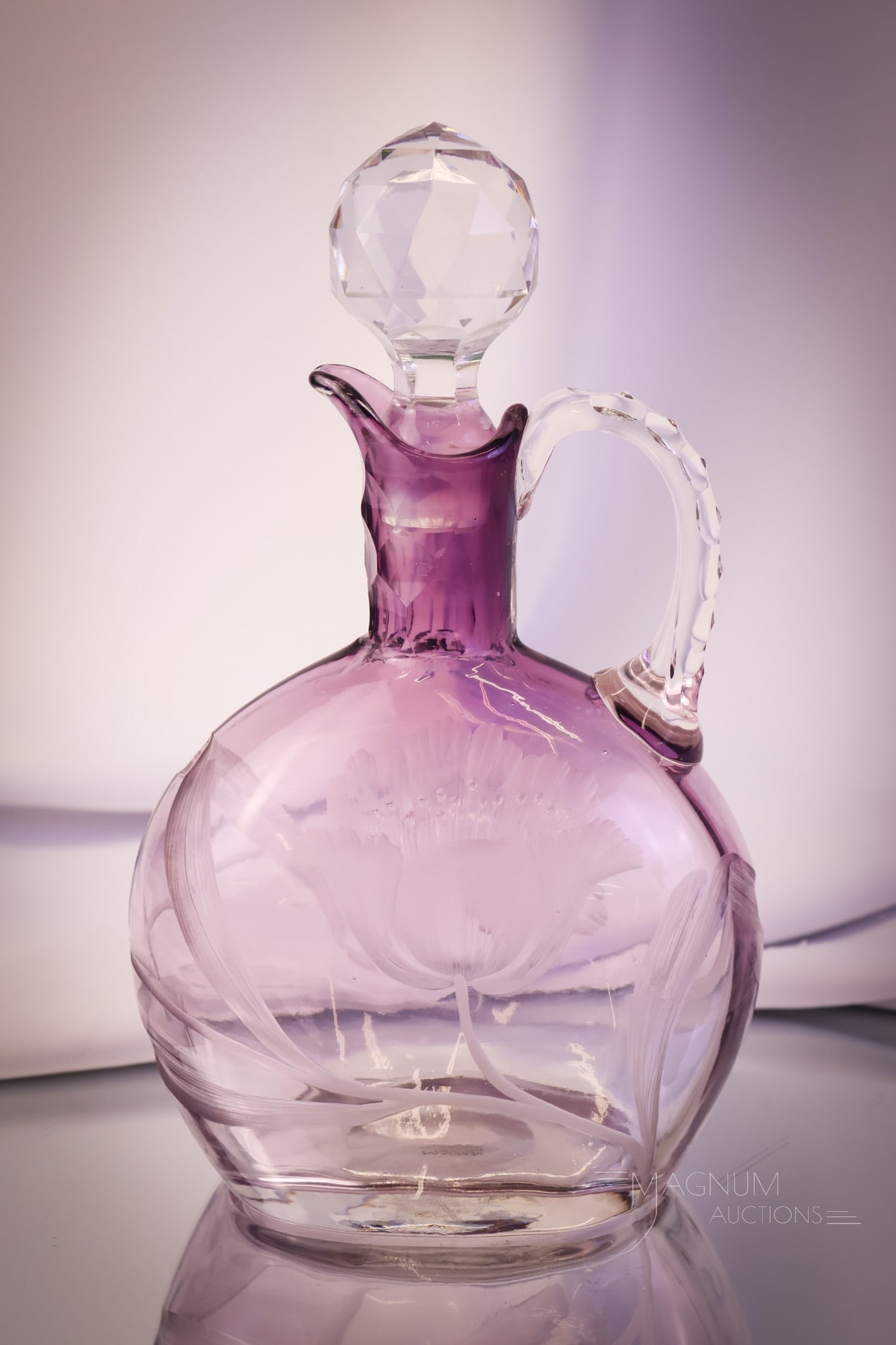 Moser Karlsbad Amethyst Art Glass Engraved Tulip Claret Decanter: A beautiful find in Moser Karlsbad signed art glass. This claret decanter is in amethyst to clear glass. It is engraved with tulips and foliage. The claret features a cut faceted stopper. The claret d