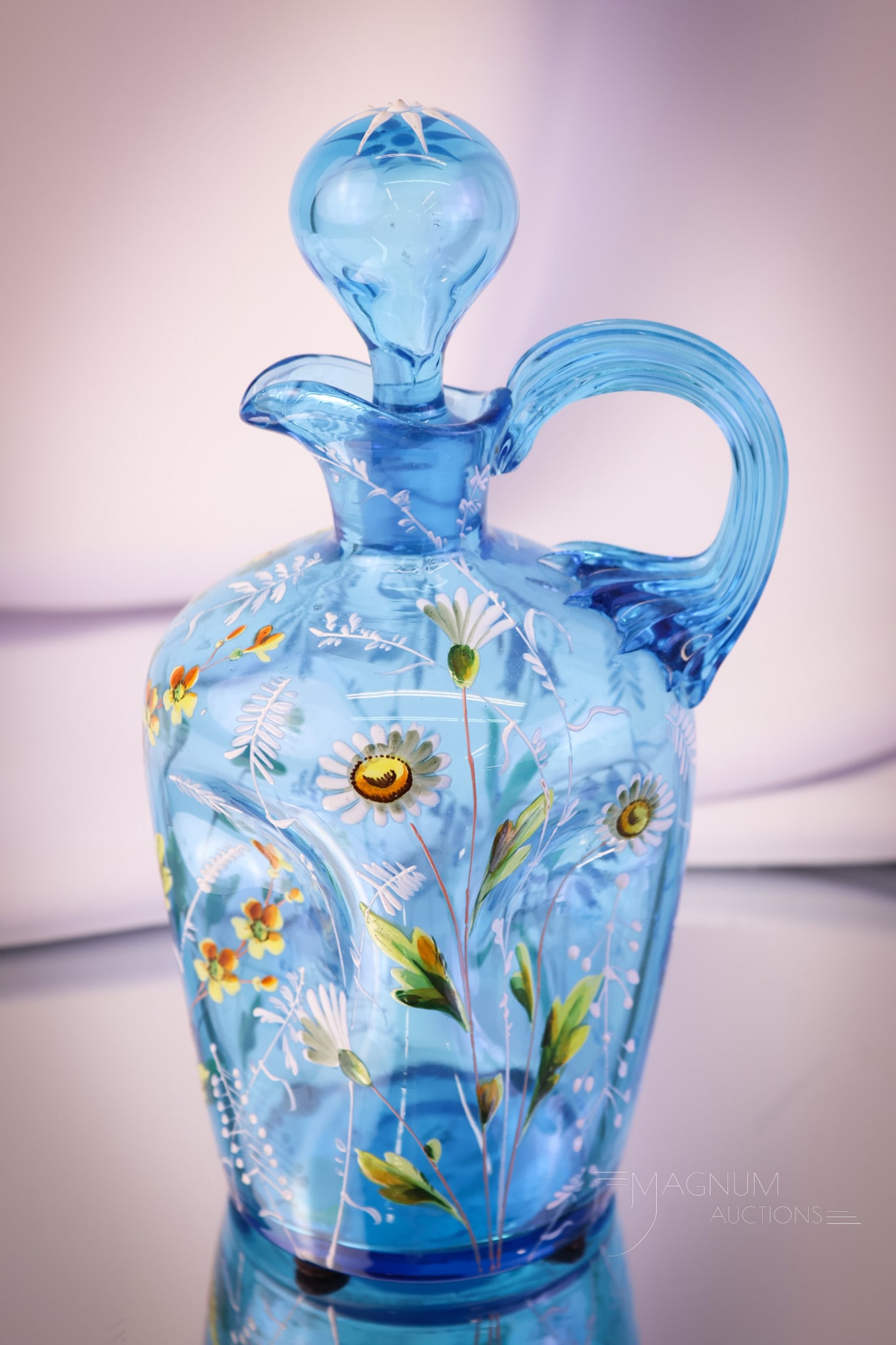 Moser Victorian Art Glass Enameled Glass Cruet: A beautiful peacock blue attributed to Moser Victorian art glass cruet. This striking example has wonderful blue coloring. The cruet features a matching stopper and an applied handle. The piece is dec