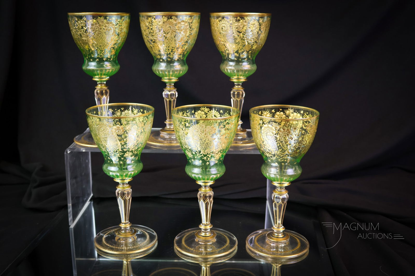 6 pc Lot Moser Uranium Art Glass Engraved Gilt Wine Stems: A delightful set of six Moser attributed wine stems. These are rich in uranium content and glow brightly under black light. Each is gilt decorated and engraved. The stems each measure 6" tall. SHIPPIN